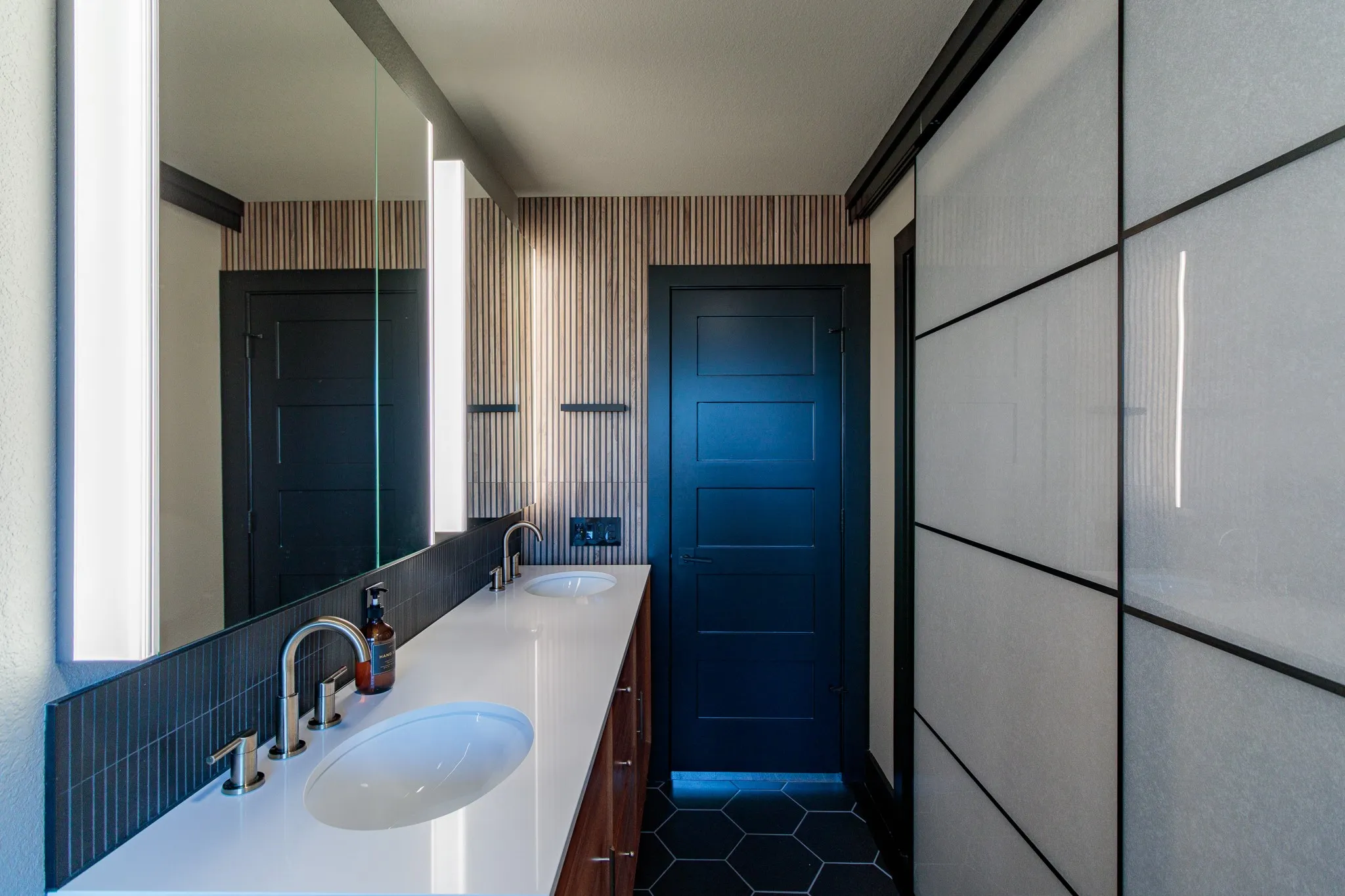 Dual vanity with integrated sinks, brushed nickel fixtures, and a white countertop
