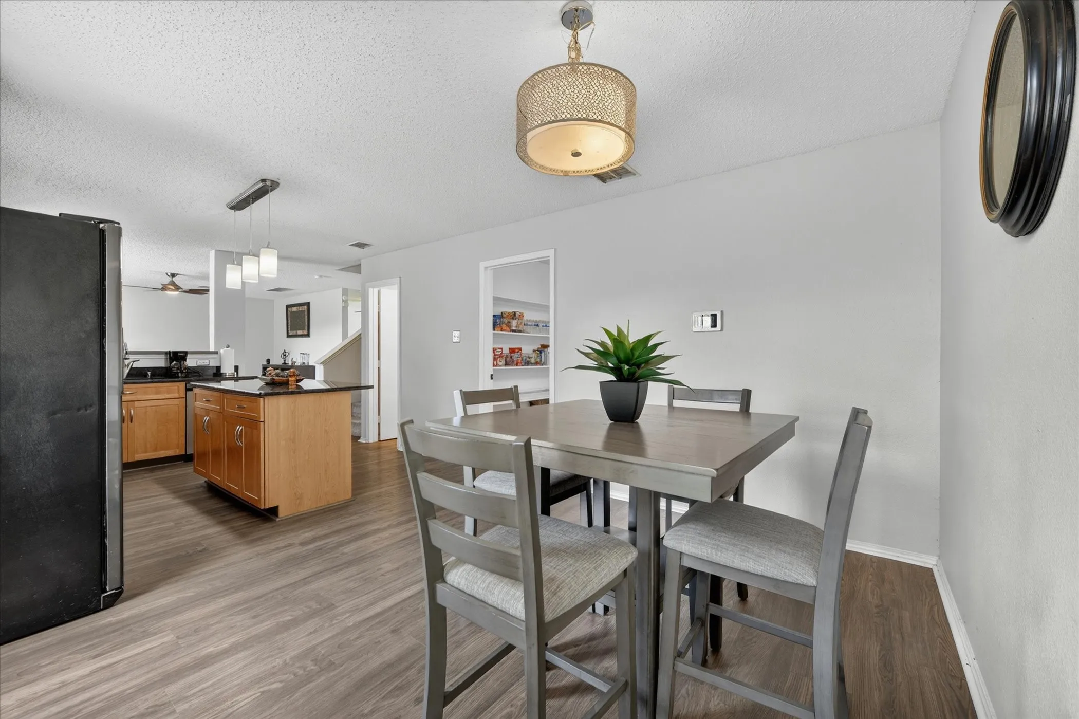 Open-concept dining area featuring wood-finish flooring
