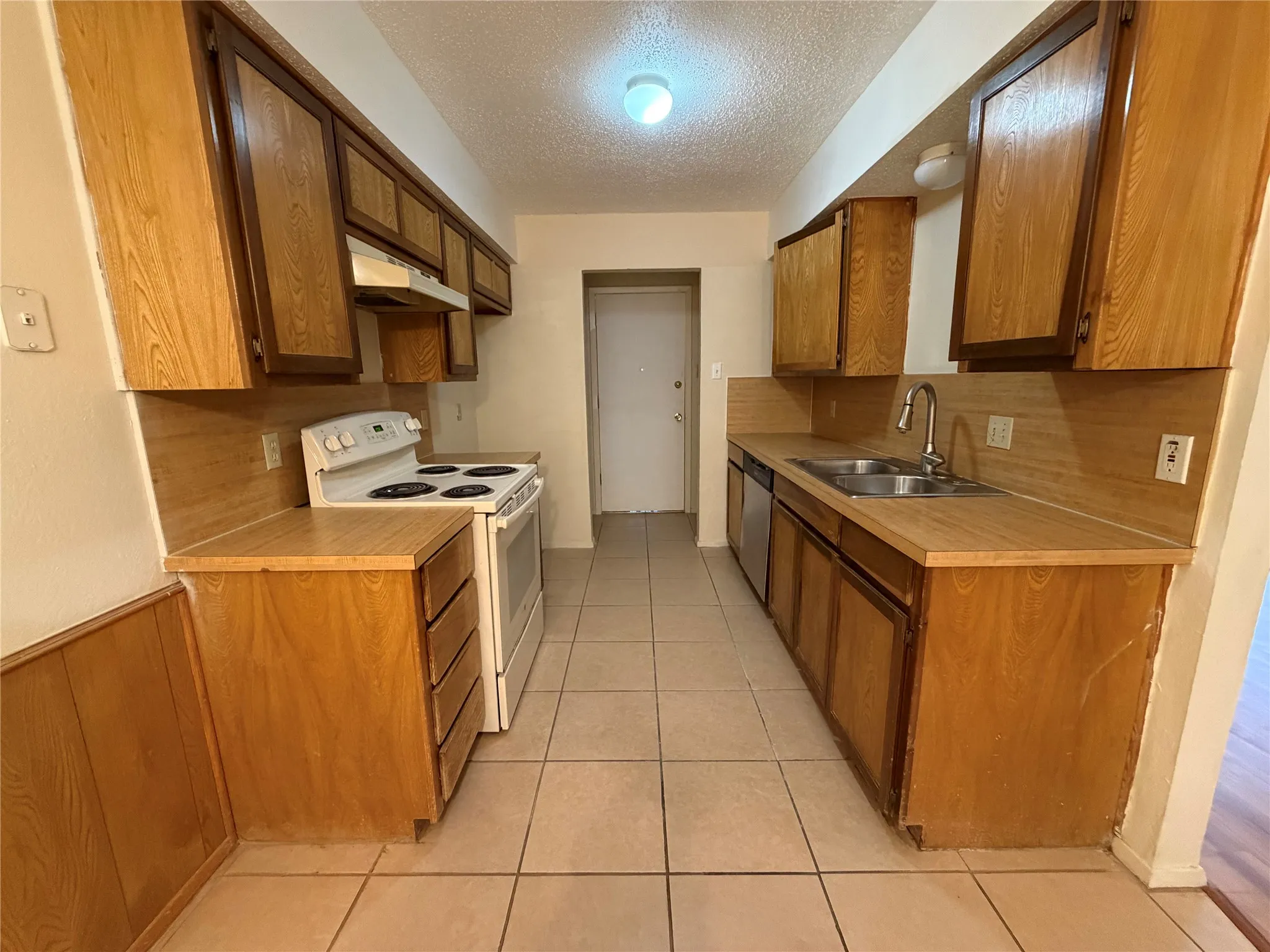 Kitchen featuring wood-finish cabinetry and countertops