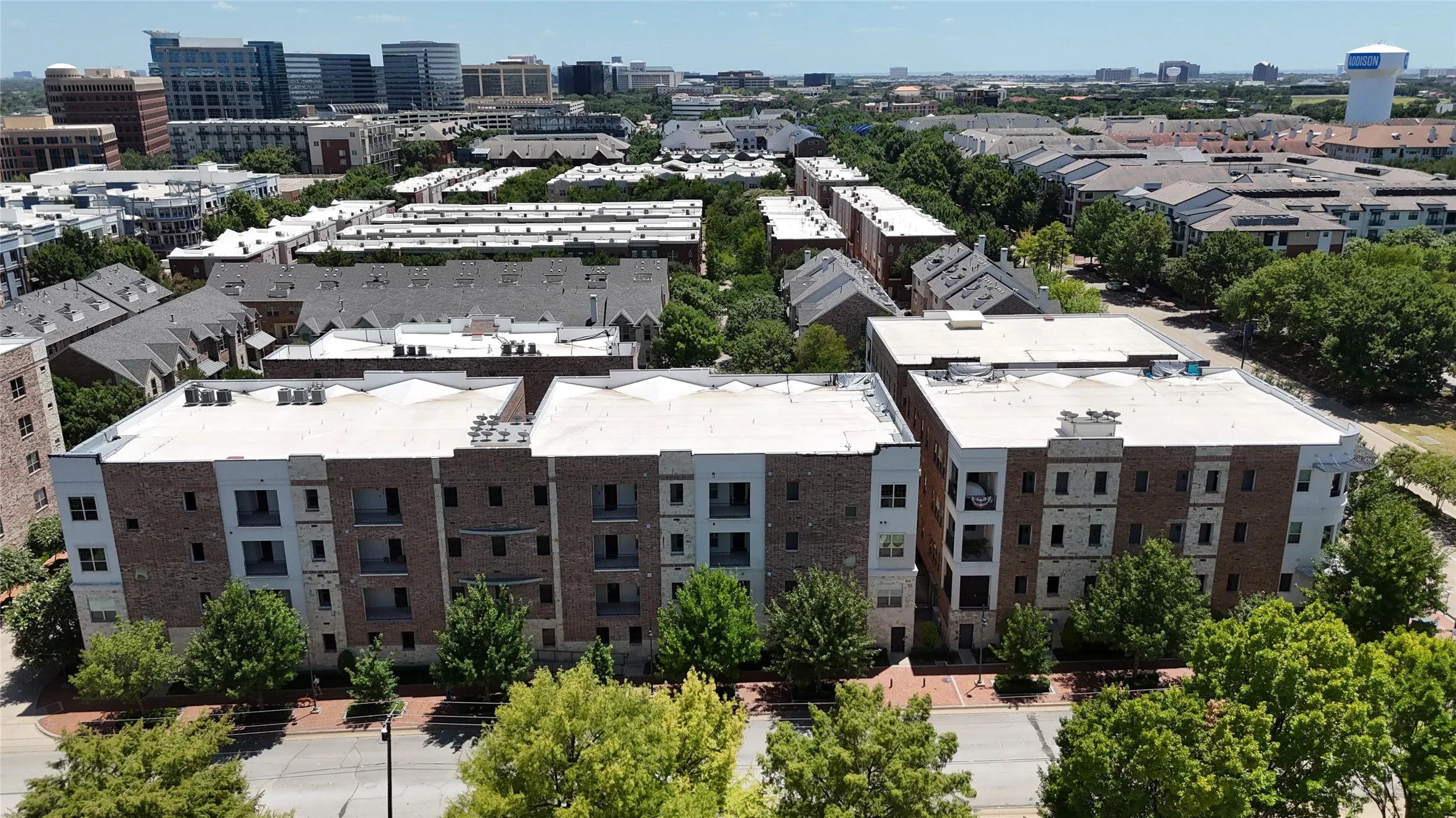 Multi-story residential buildings featuring brick and light-toned facade panels