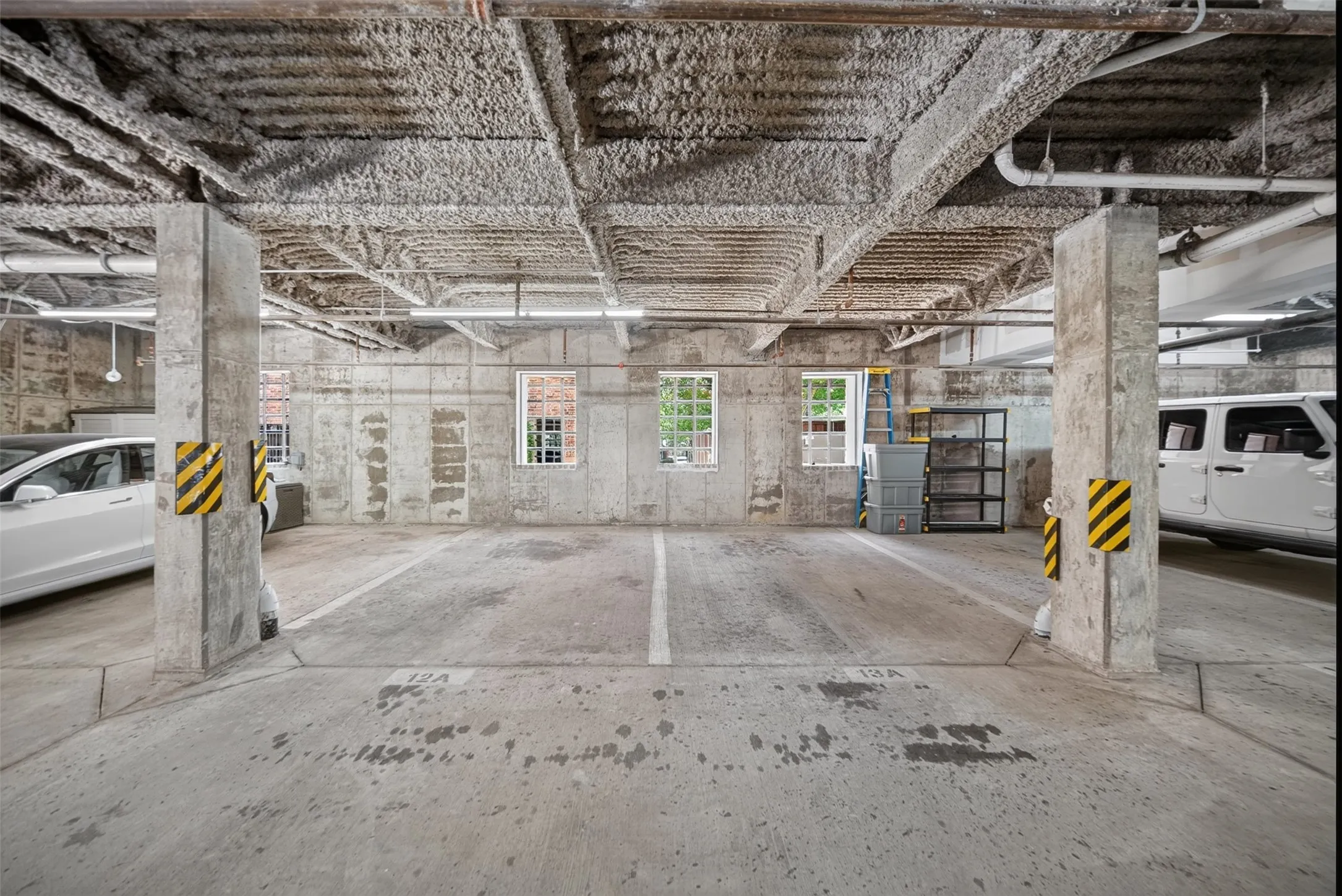 Concrete parking space with exposed concrete ceiling and support columns