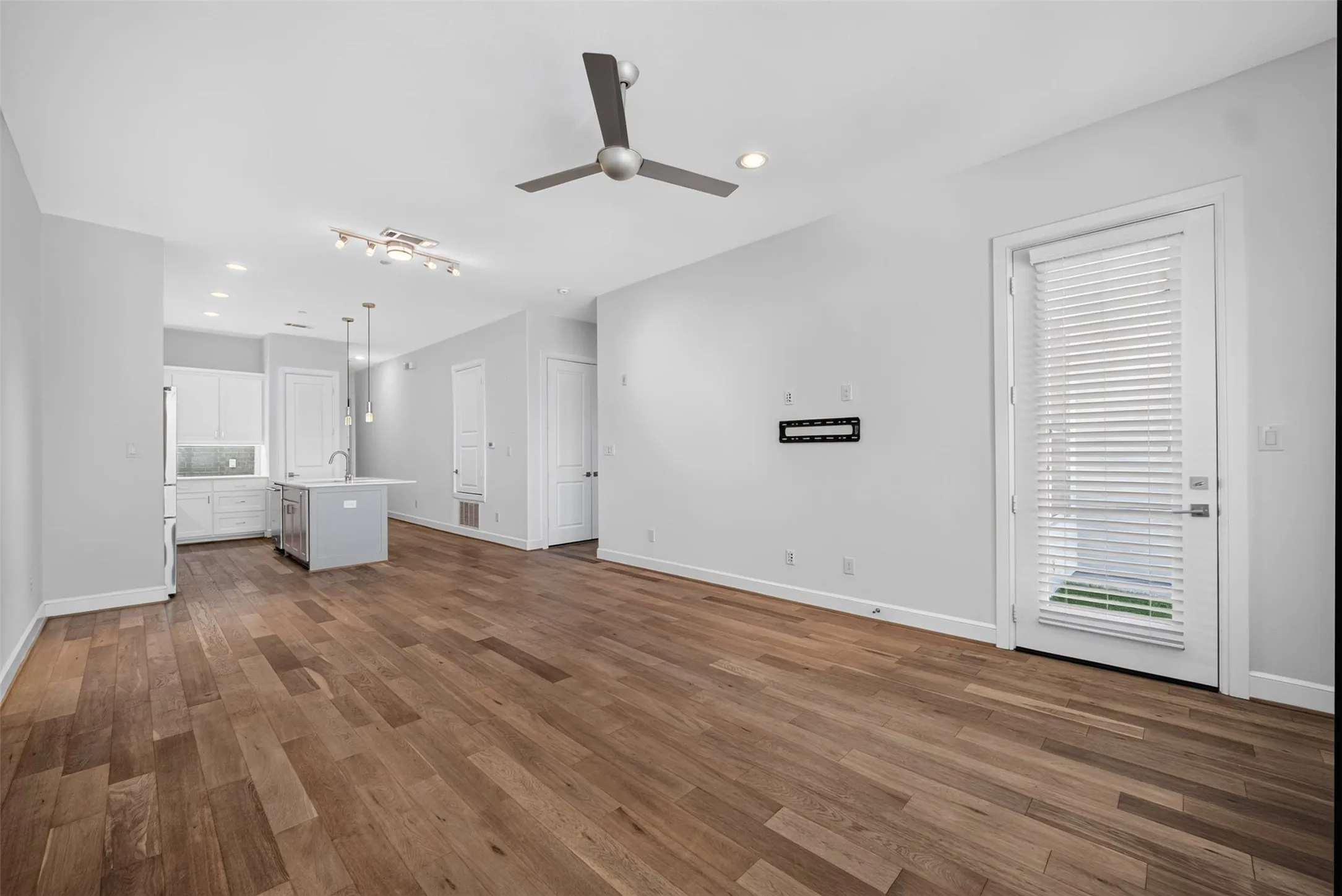 Expansive living area featuring wide plank wood-finish flooring