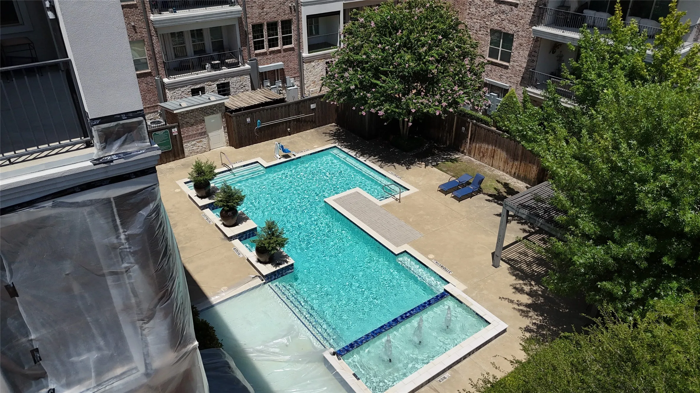 Community swimming pool featuring a multi-level design and integrated water features