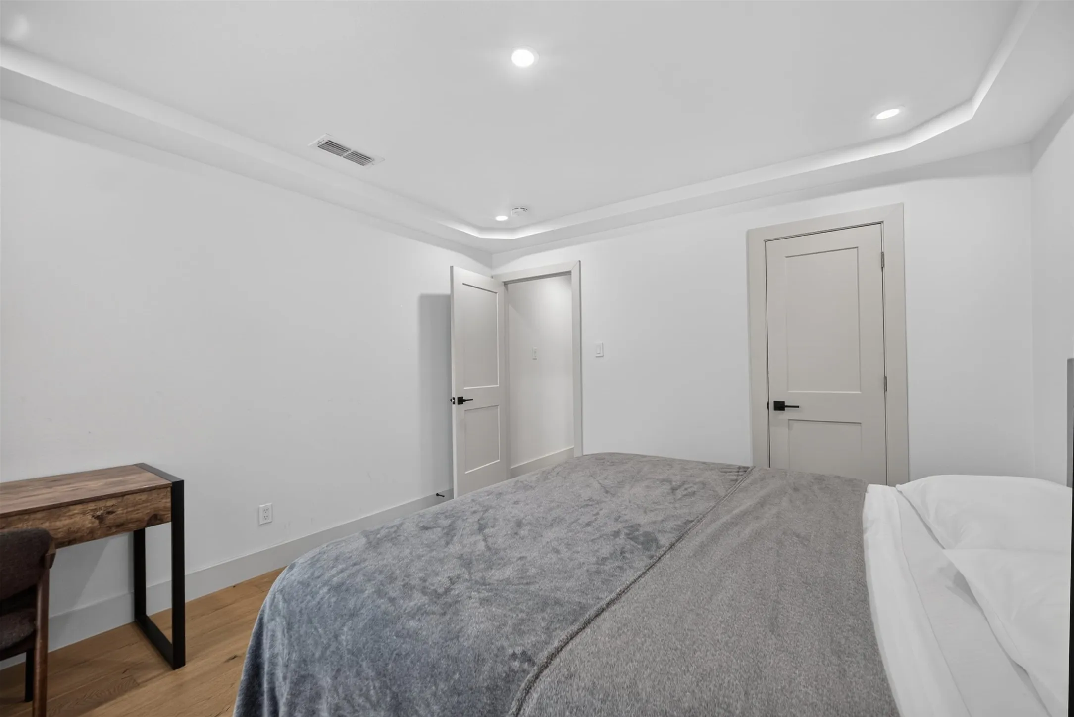 Recessed lighting and crown molding accentuate the ceiling