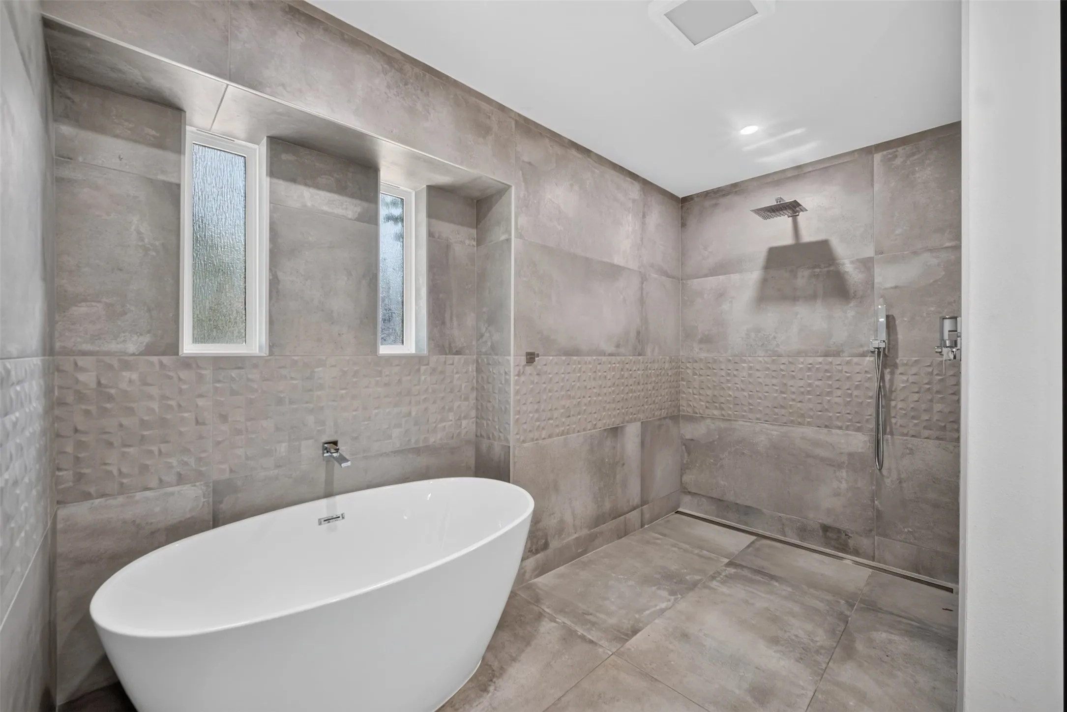 Freestanding soaking tub and walk-in shower with a rain showerhead