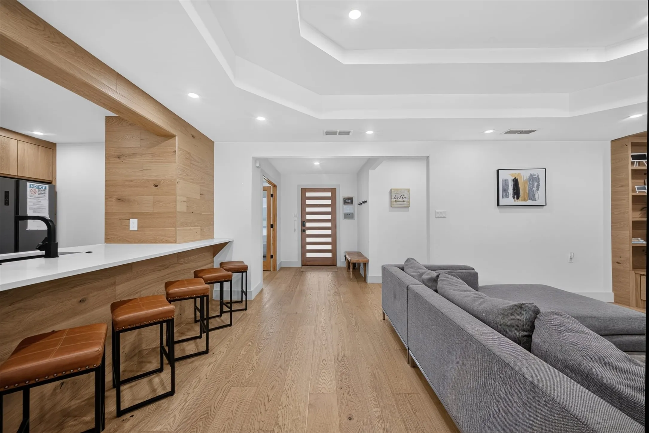 Open-concept living space with light wood-finish flooring throughout