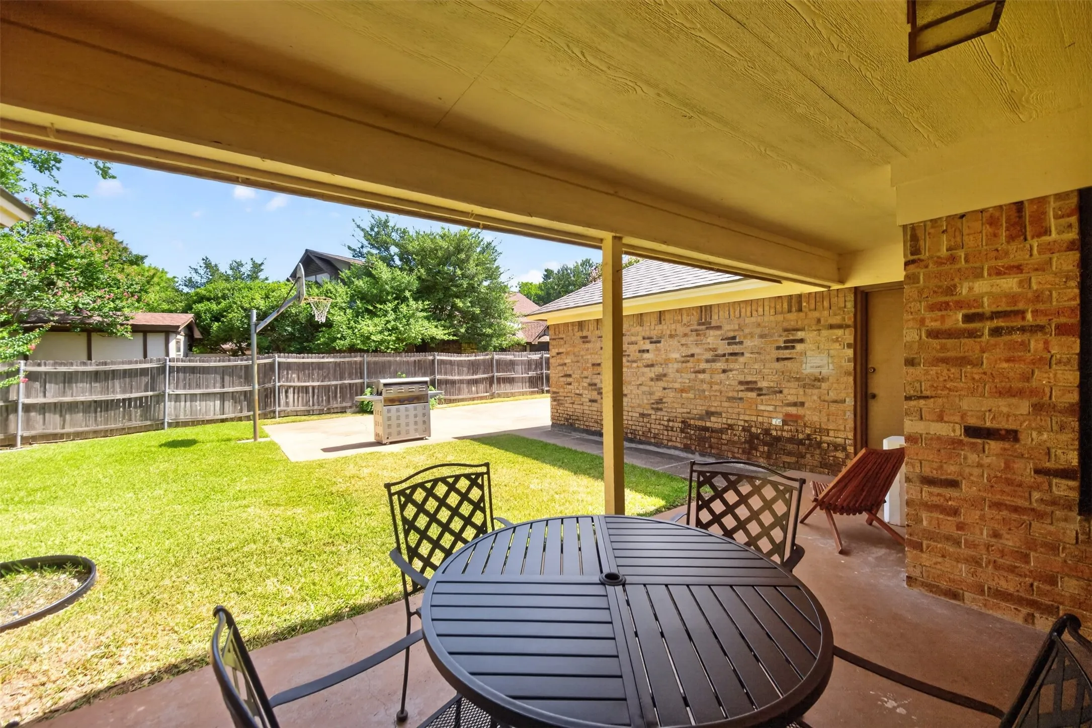 Covered patio with a concrete surface and brick exterior