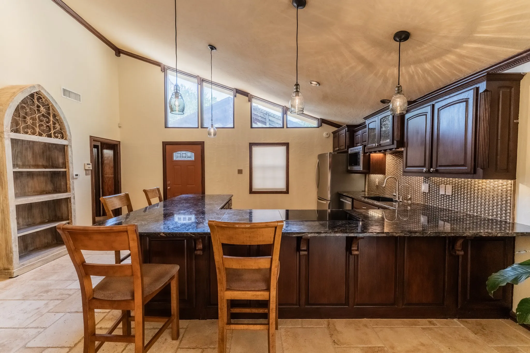 Kitchen has ample counter space, and many custom cabinets.