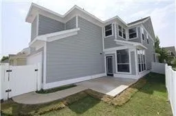 Back of house featuring a patio area and a gate