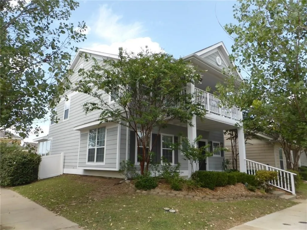 View of property exterior featuring a balcony and covered porch