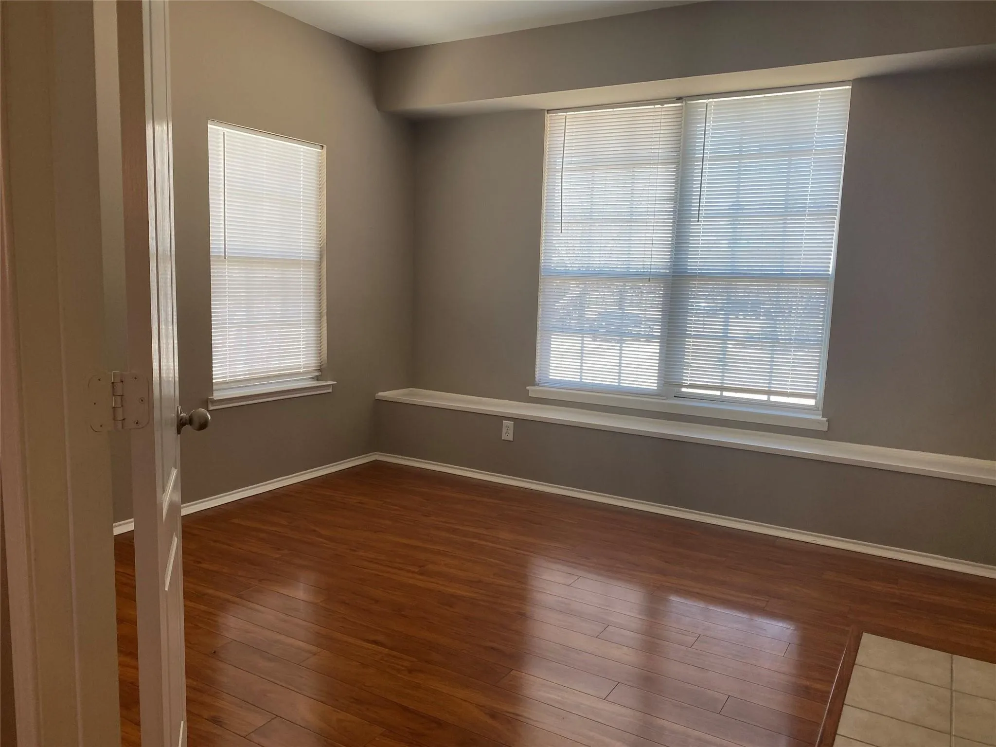 Unfurnished room featuring plenty of natural light and wood finished floors