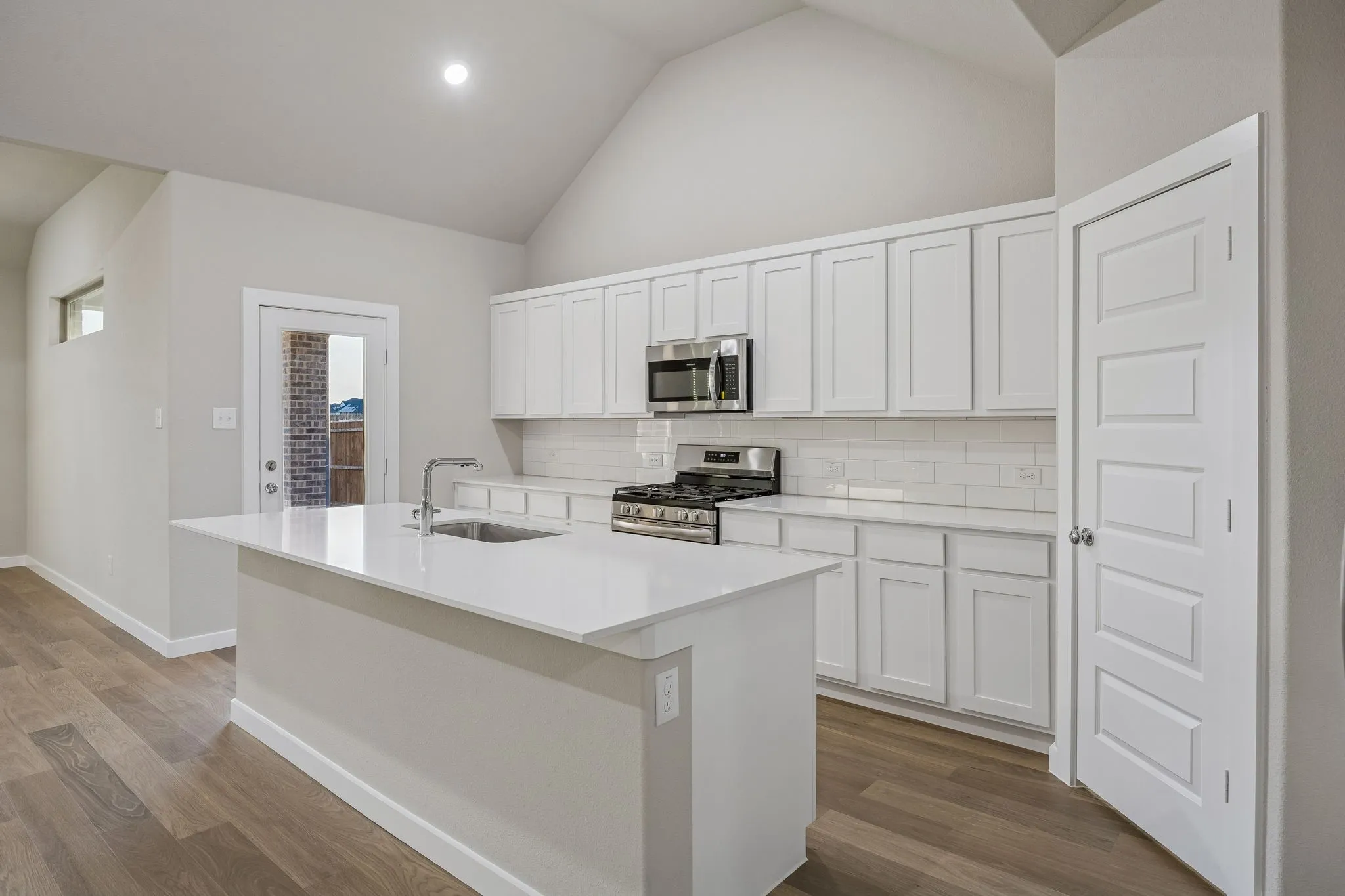 Kitchen in the Wimbledon home plan by Trophy Signature Homes – REPRESENTATIVE PHOTO