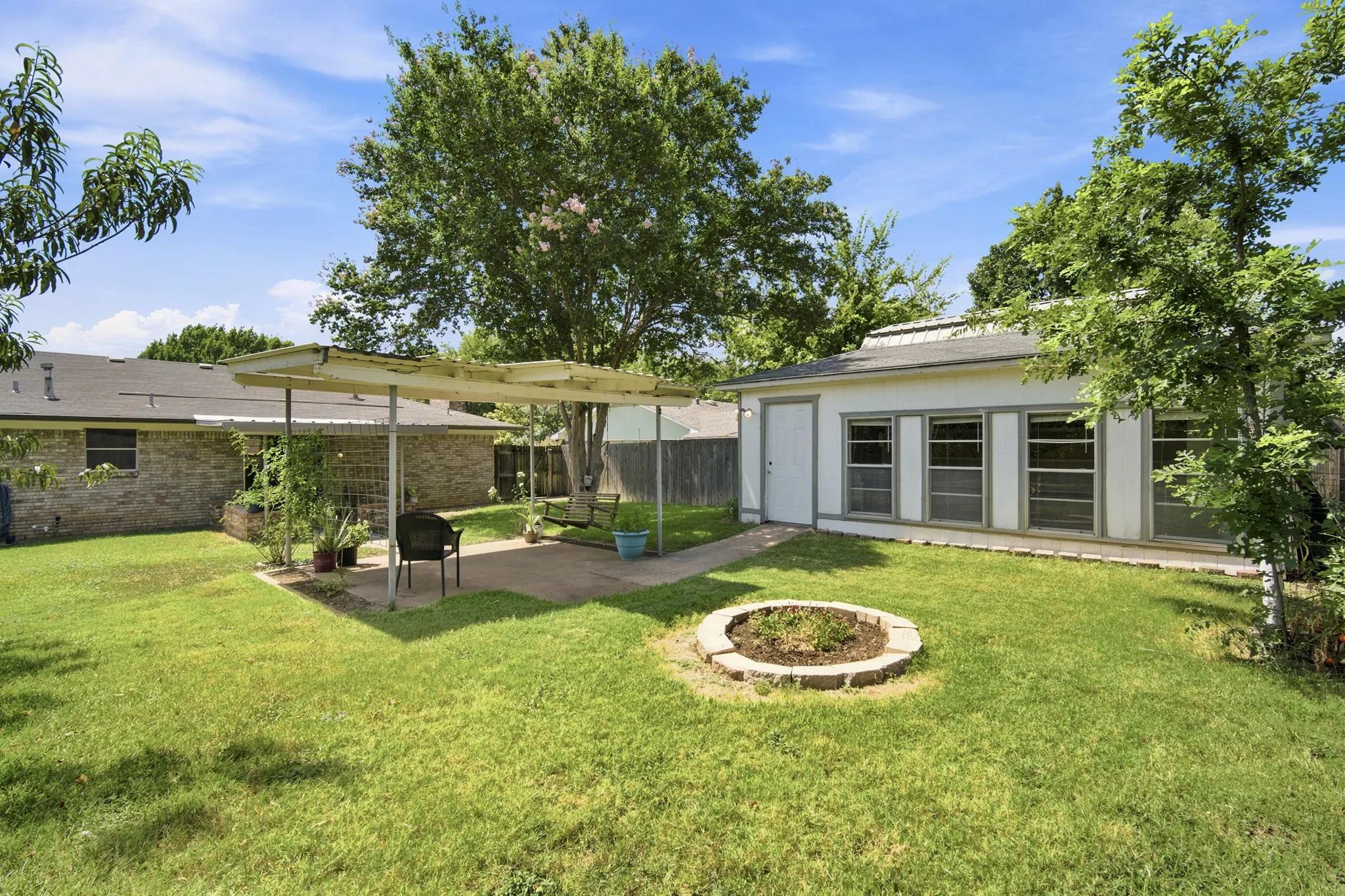 Backyard with covered patio space and workshop