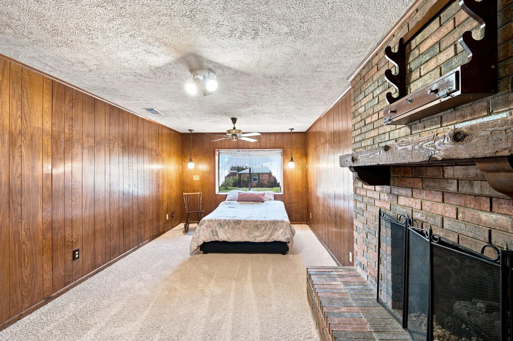 Brick fireplace with a substantial wood mantel