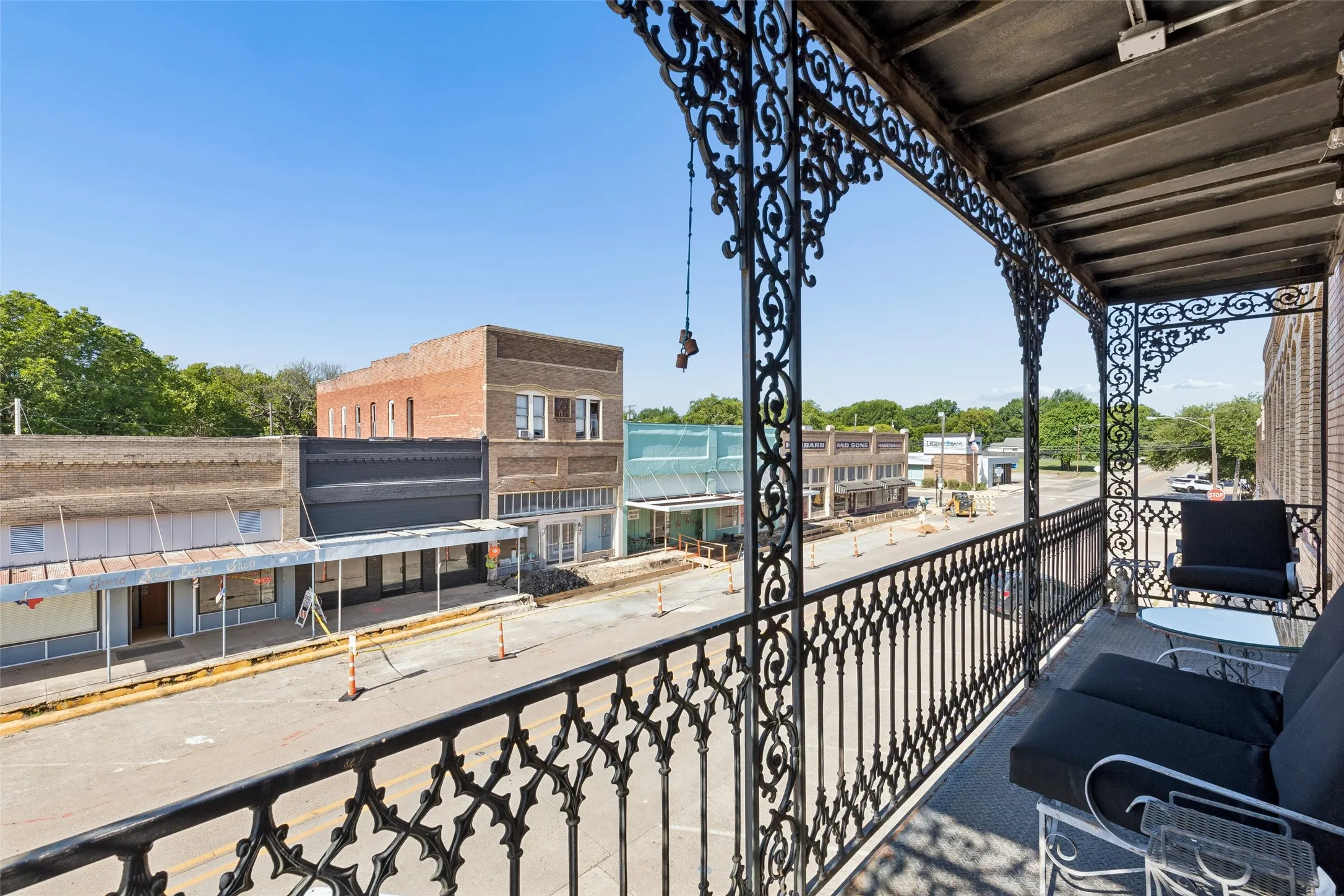 Balcony featuring ornate black ironwork and a concrete floor
