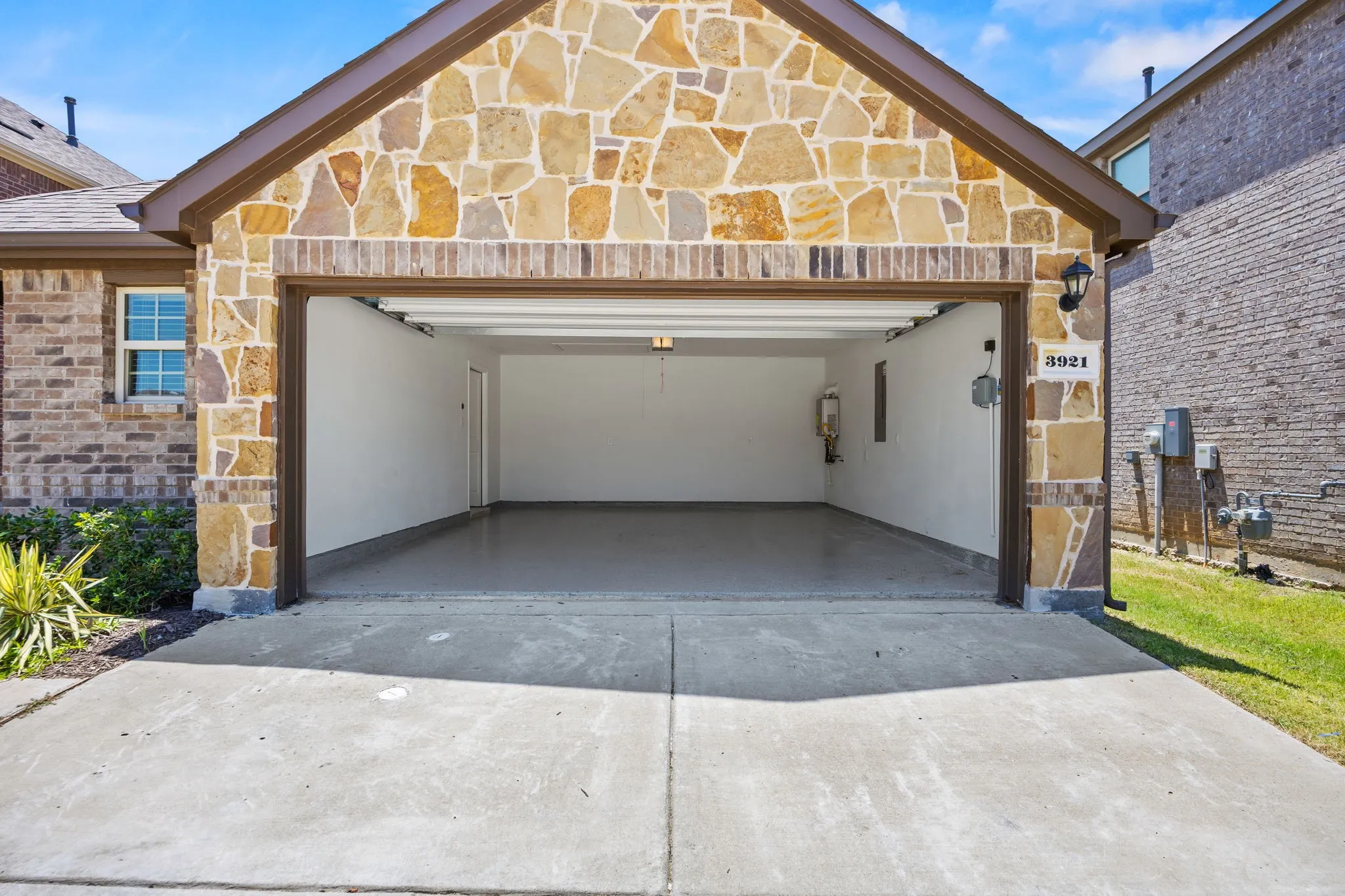 Finished garage with paint, epoxy flooring, and tankless water heater