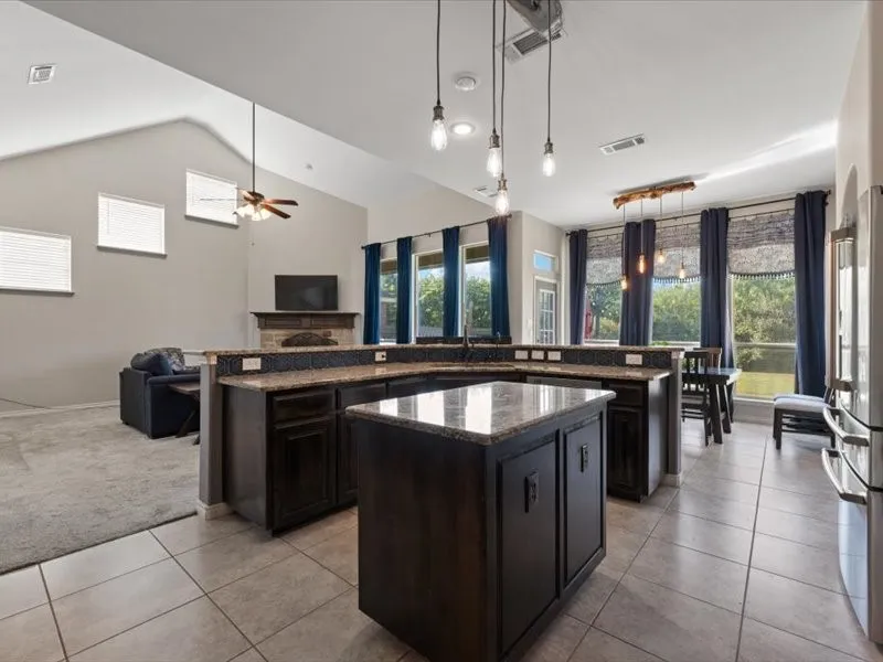 Open layout with expansive windows of the private backyard