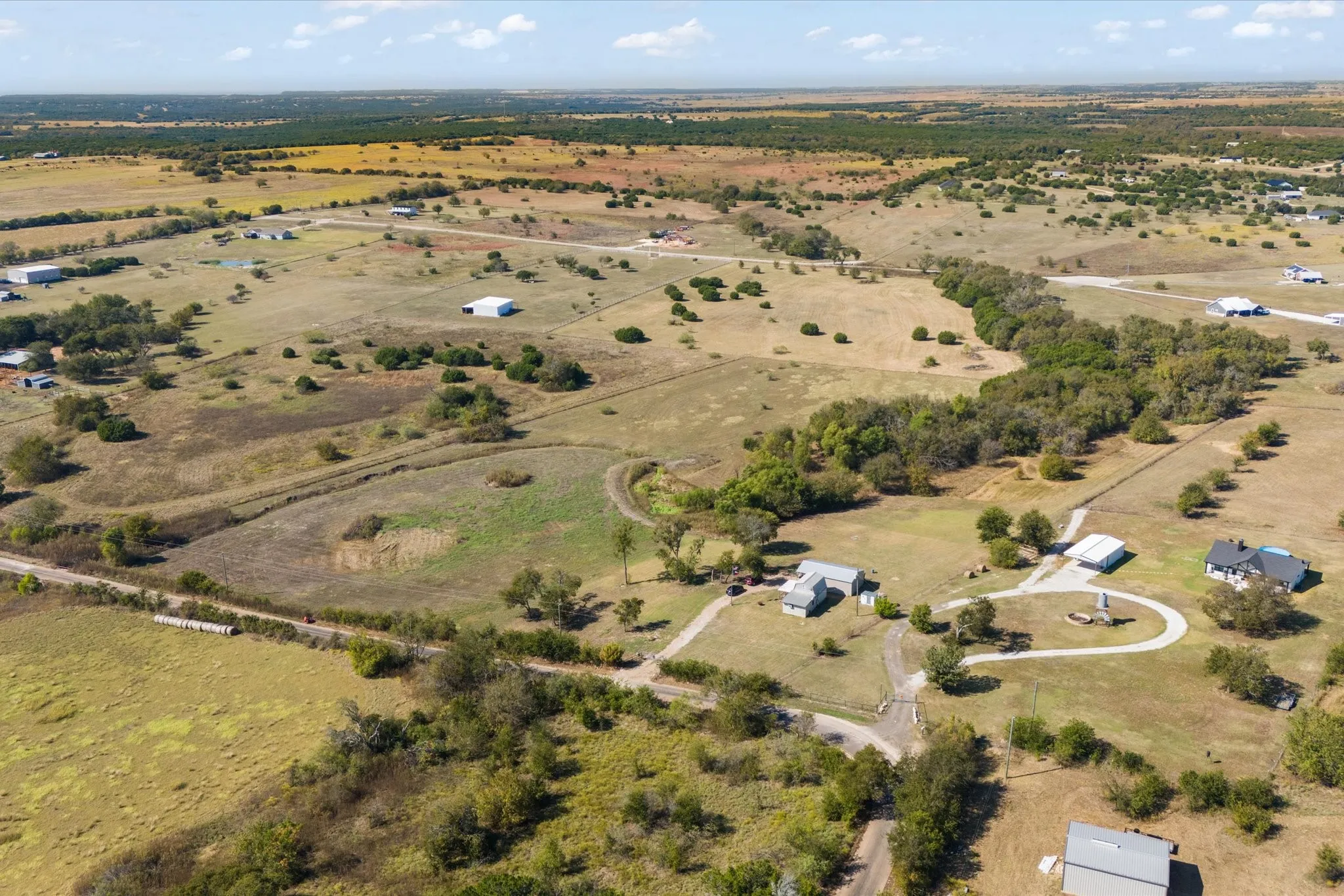 Expansive acreage featuring multiple residential structures and outbuildings