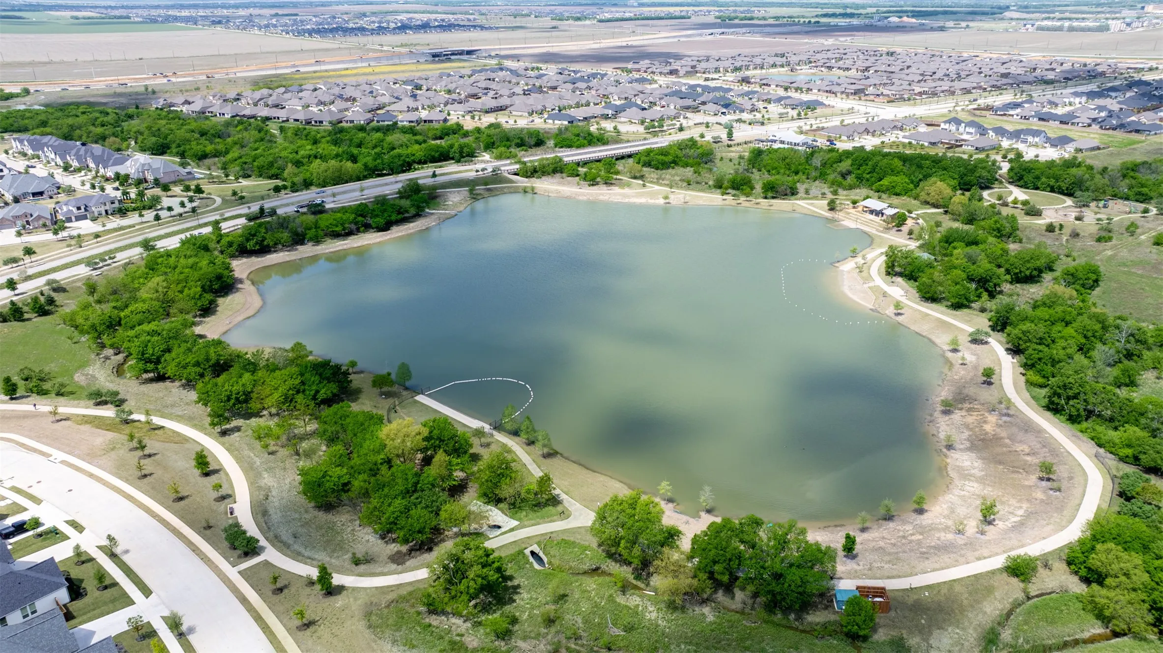 Community pond with beach area and dog parks