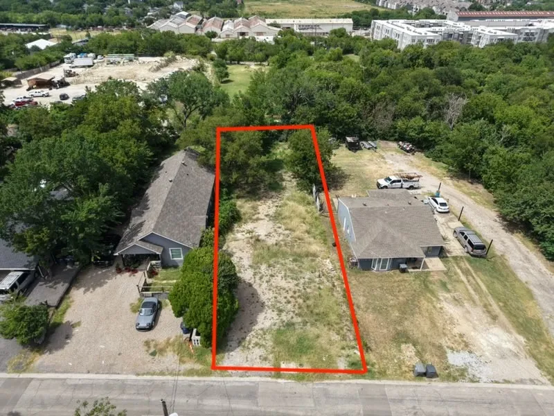 Cleared land parcel featuring mature trees, a level grade, and roadside frontage