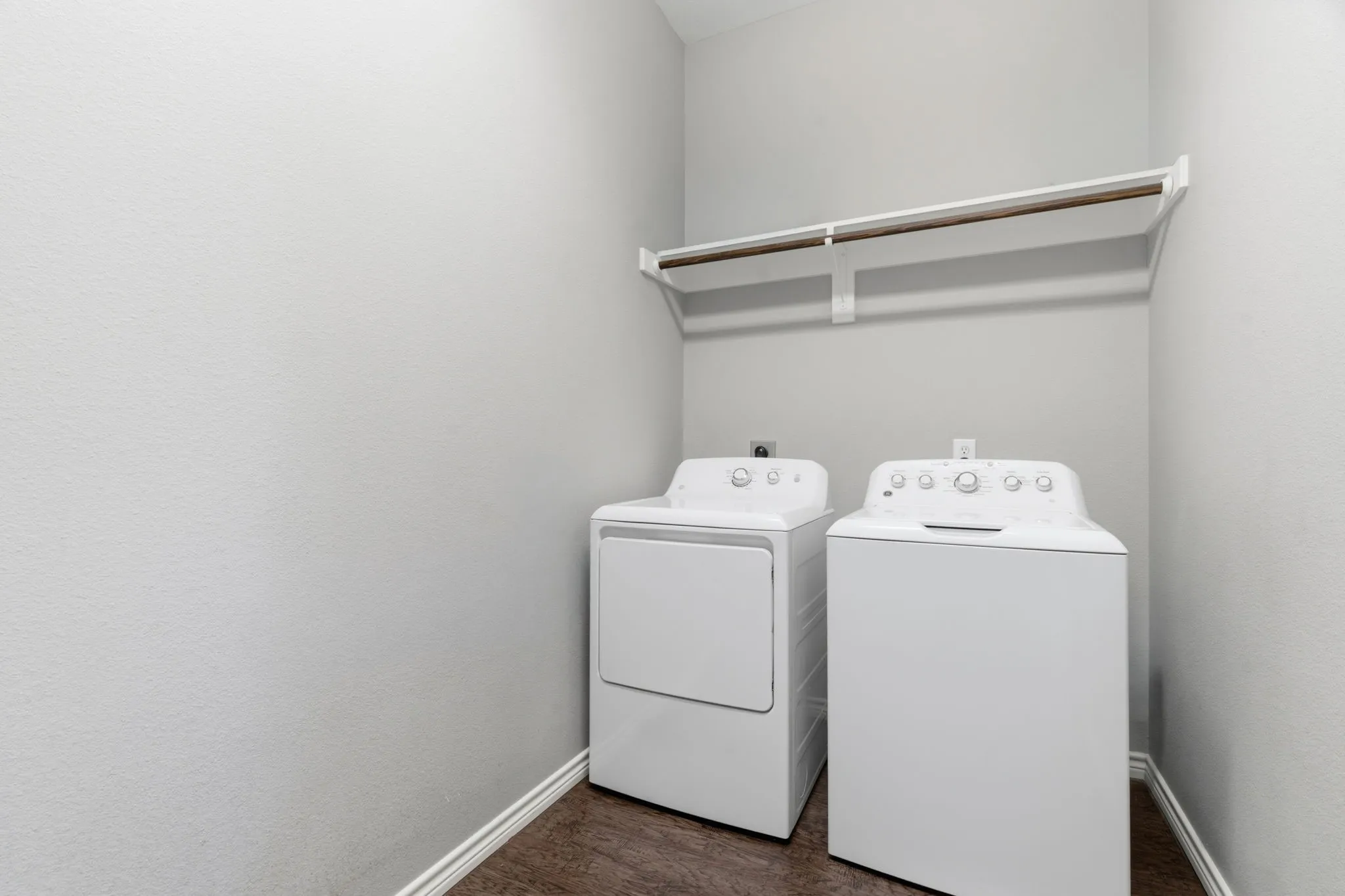 Laundry room featuring separate washer and dryer and dark wood-style floors