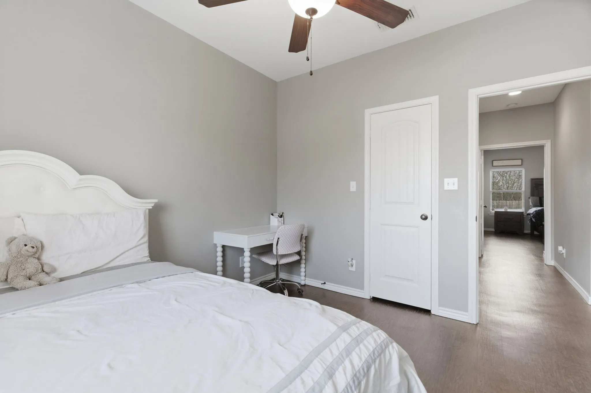 Bedroom with a ceiling fan and dark wood-style flooring