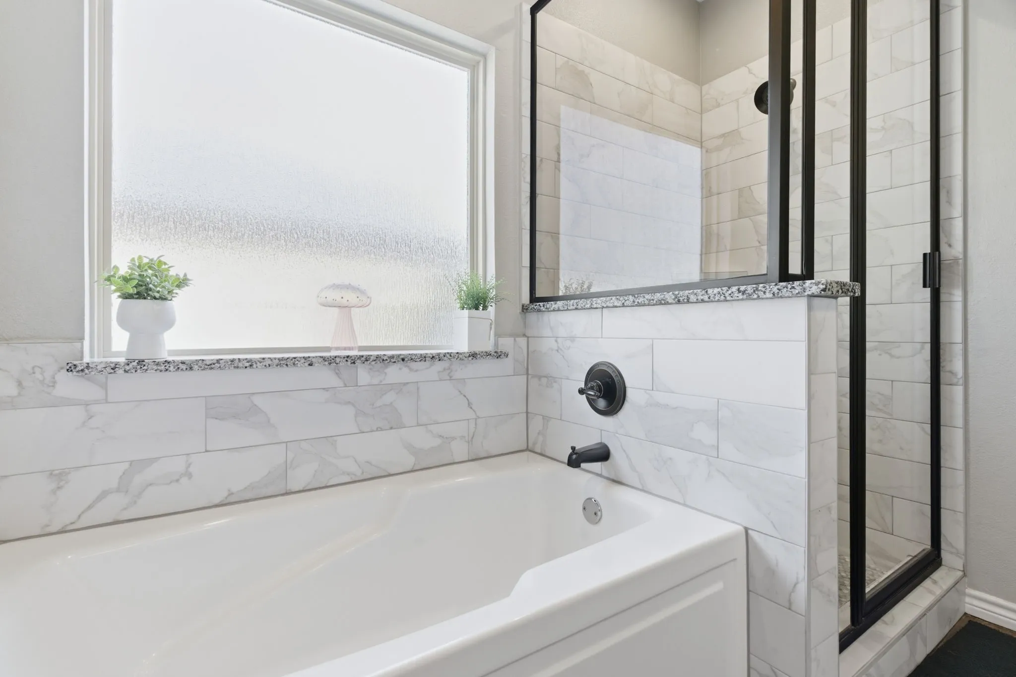 Full bathroom featuring a garden tub and a shower stall