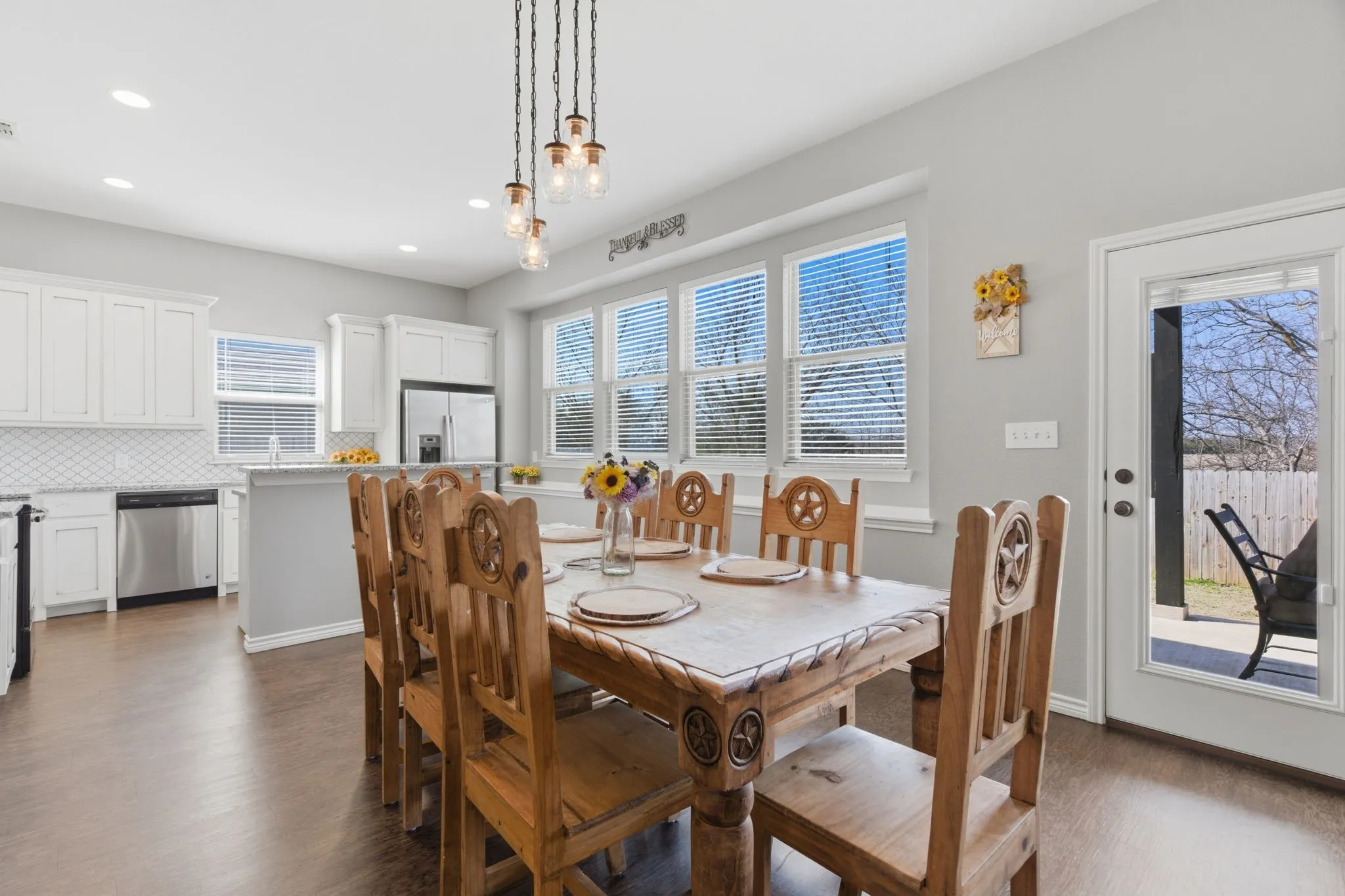 Dining space with dark wood-style flooring and baseboards