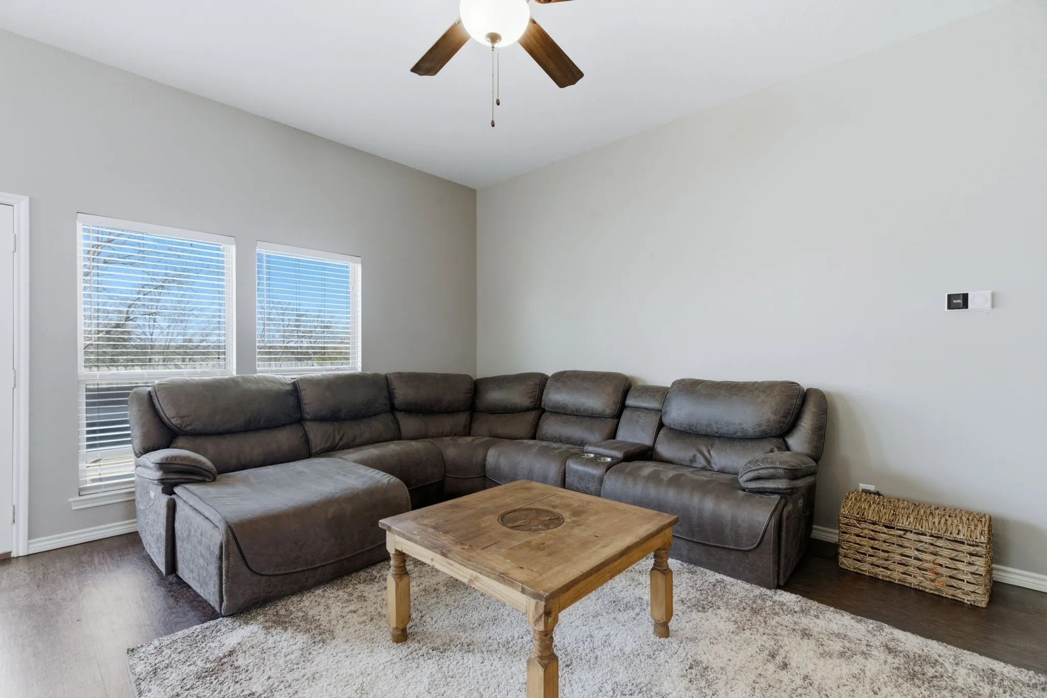 Living room featuring ceiling fan and wood finished floors