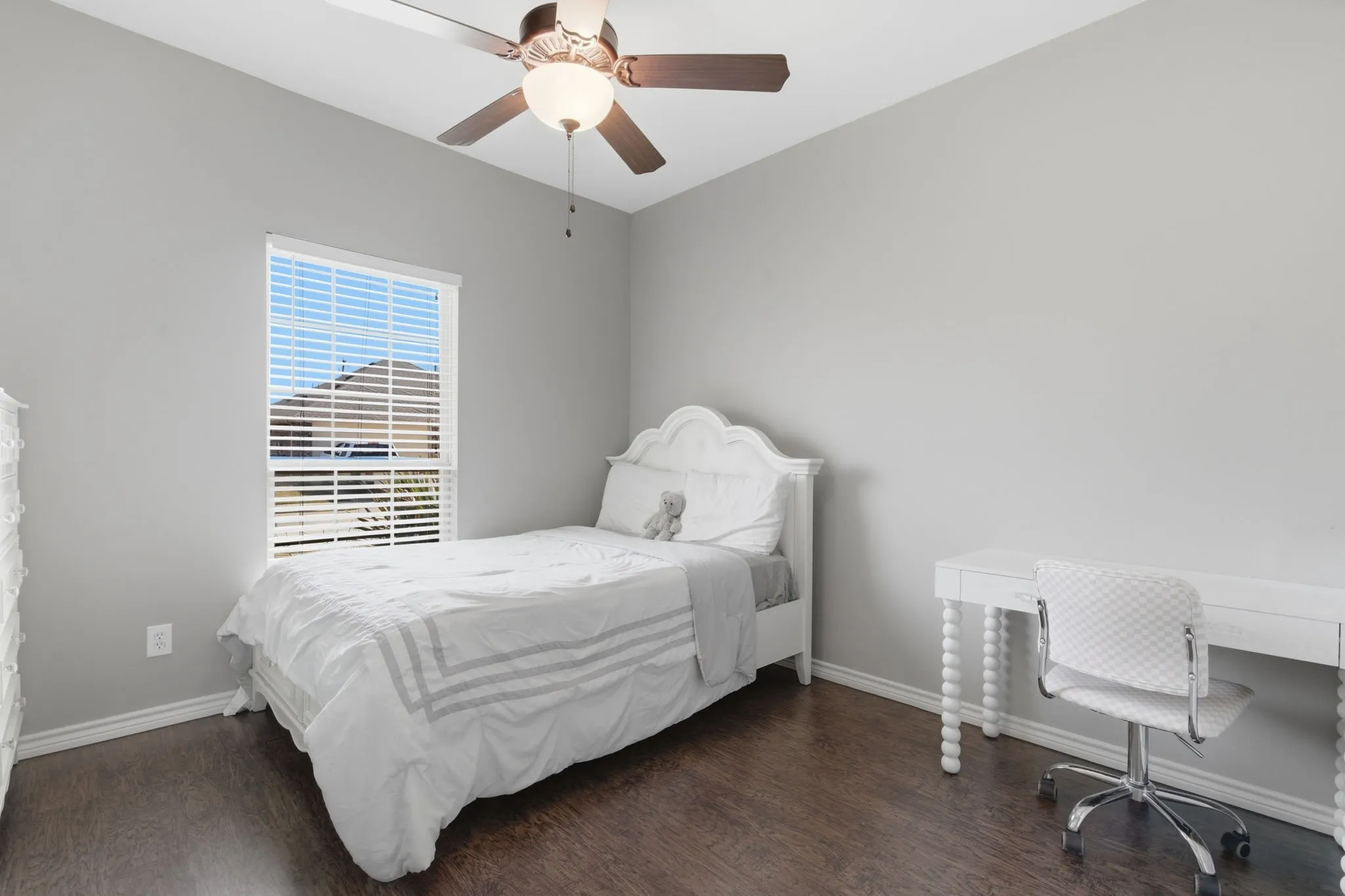Bedroom with dark wood finished floors, a desk, and ceiling fan