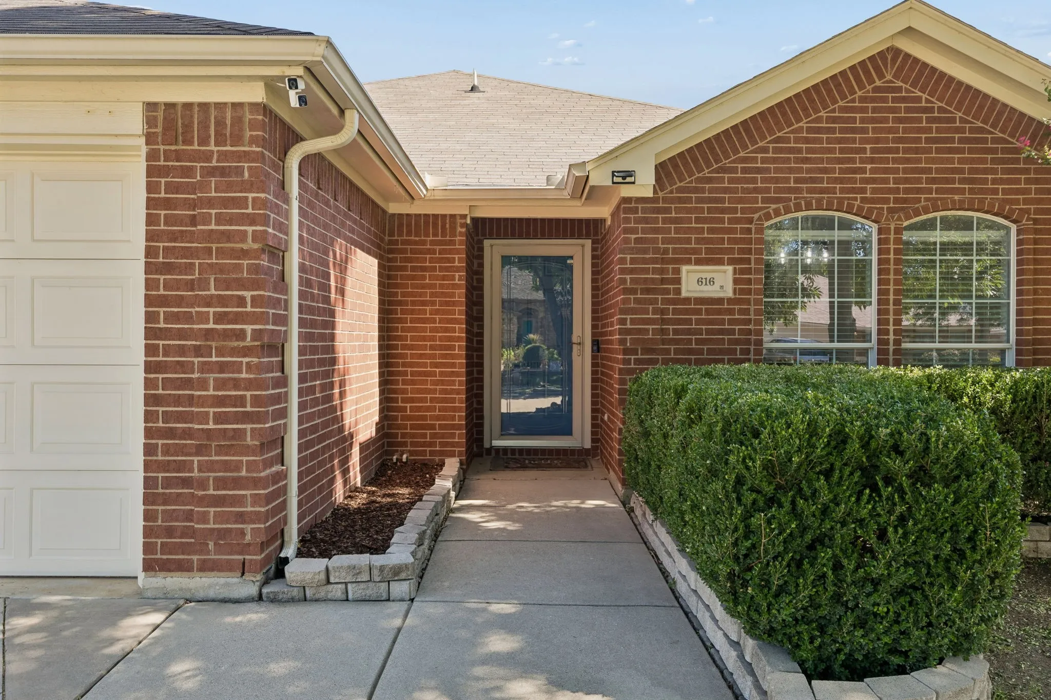 Front walkway with view of front door and glass storm door