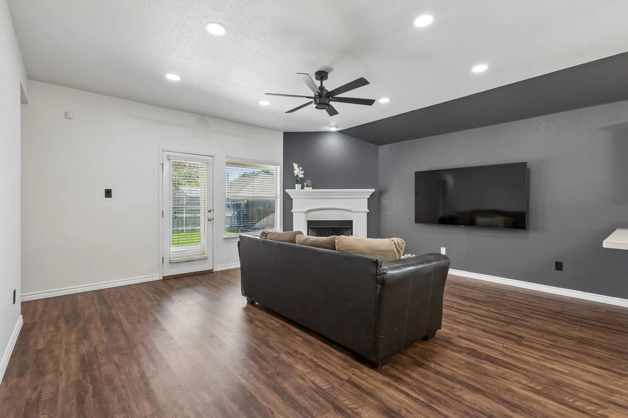 Living room with accent wall and wood burning fireplace