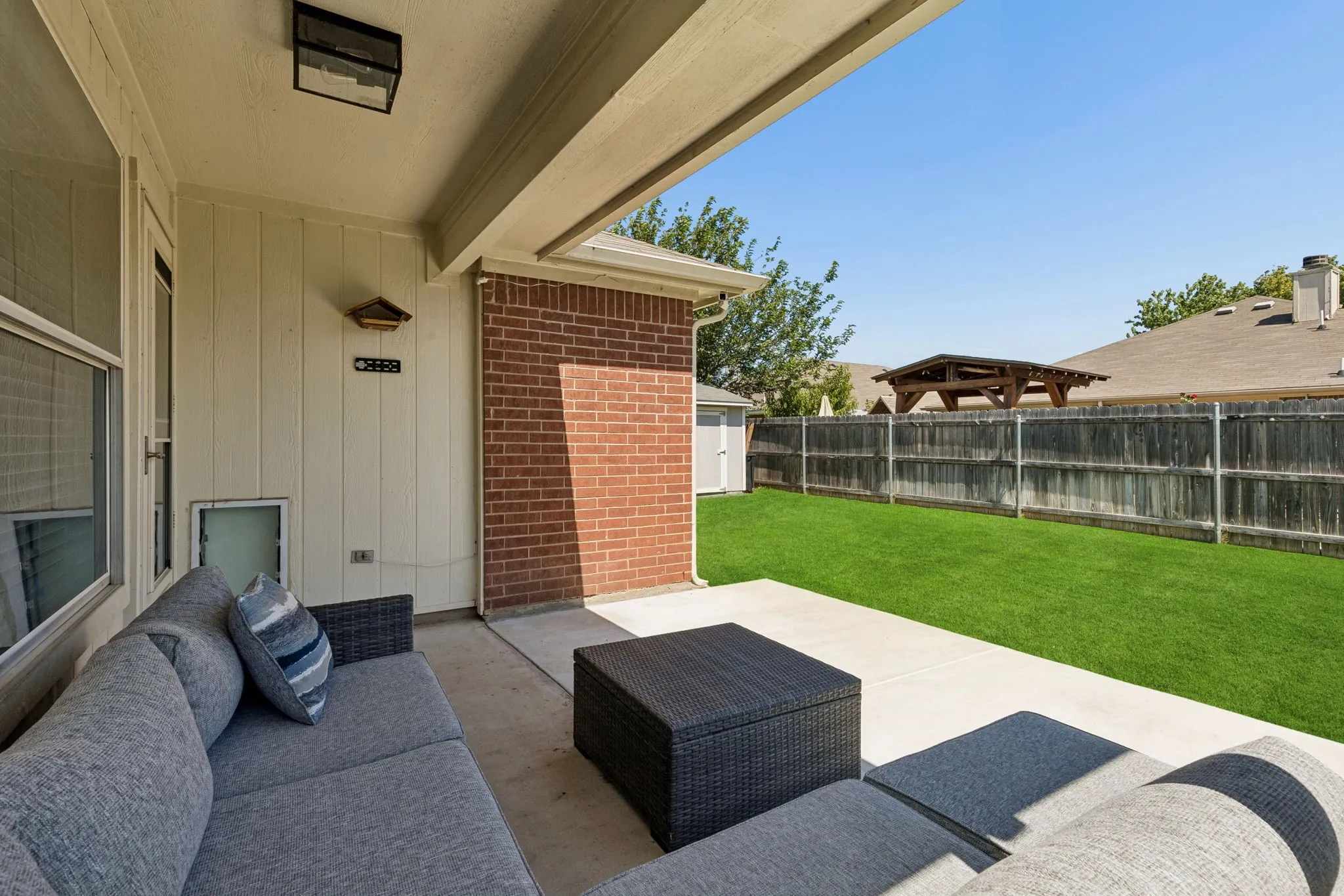 Covered back patio showcasing the extended concrete