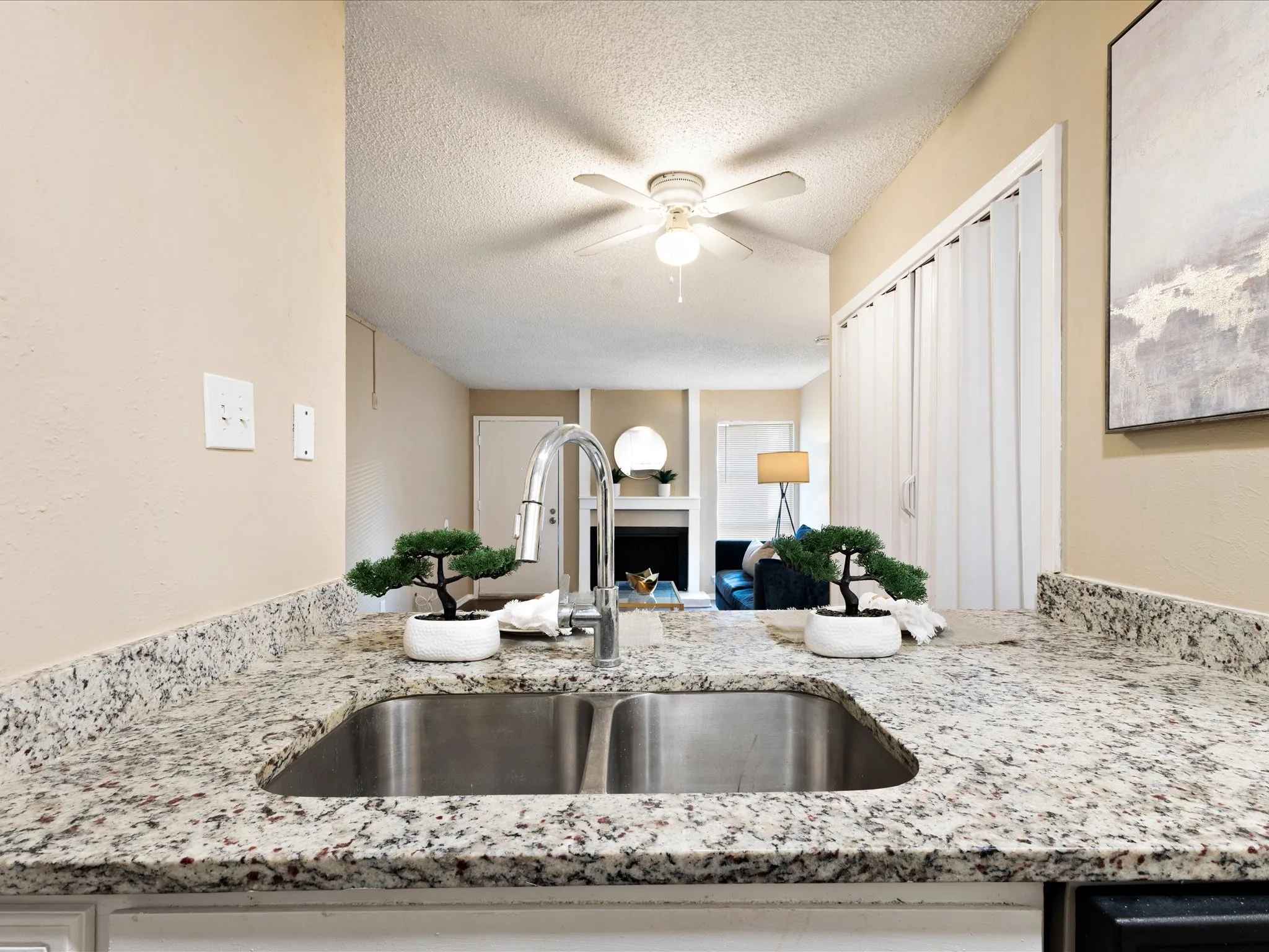 Kitchen featuring a double basin stainless steel sink, gooseneck faucet, and granite countertops
