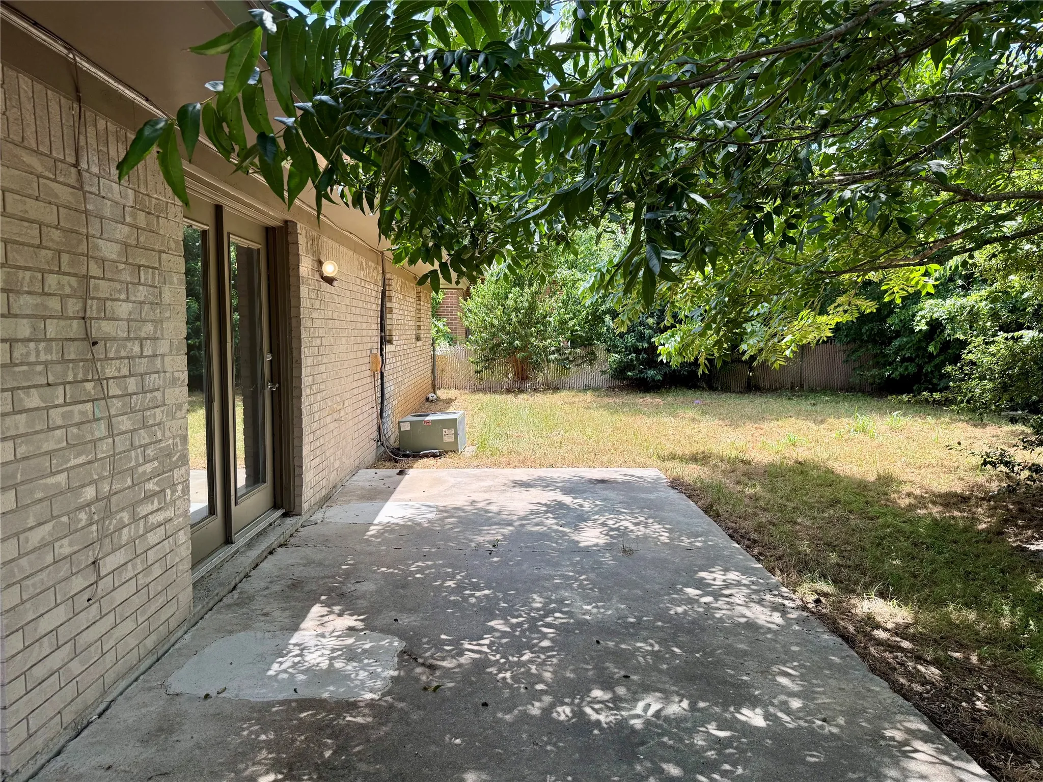 Expansive backyard with a concrete patio