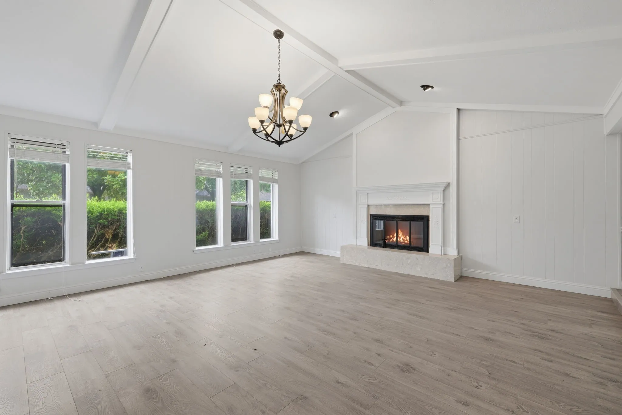 Spacious interior with vaulted ceilings and wood-finish flooring