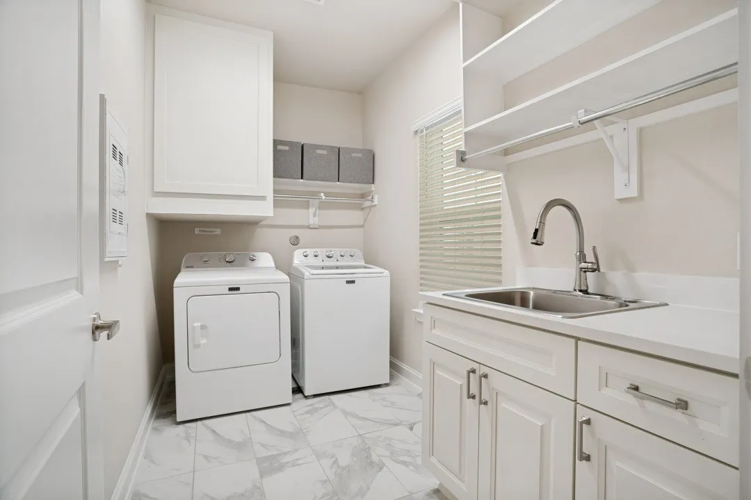 Laundry with sink and cabinets