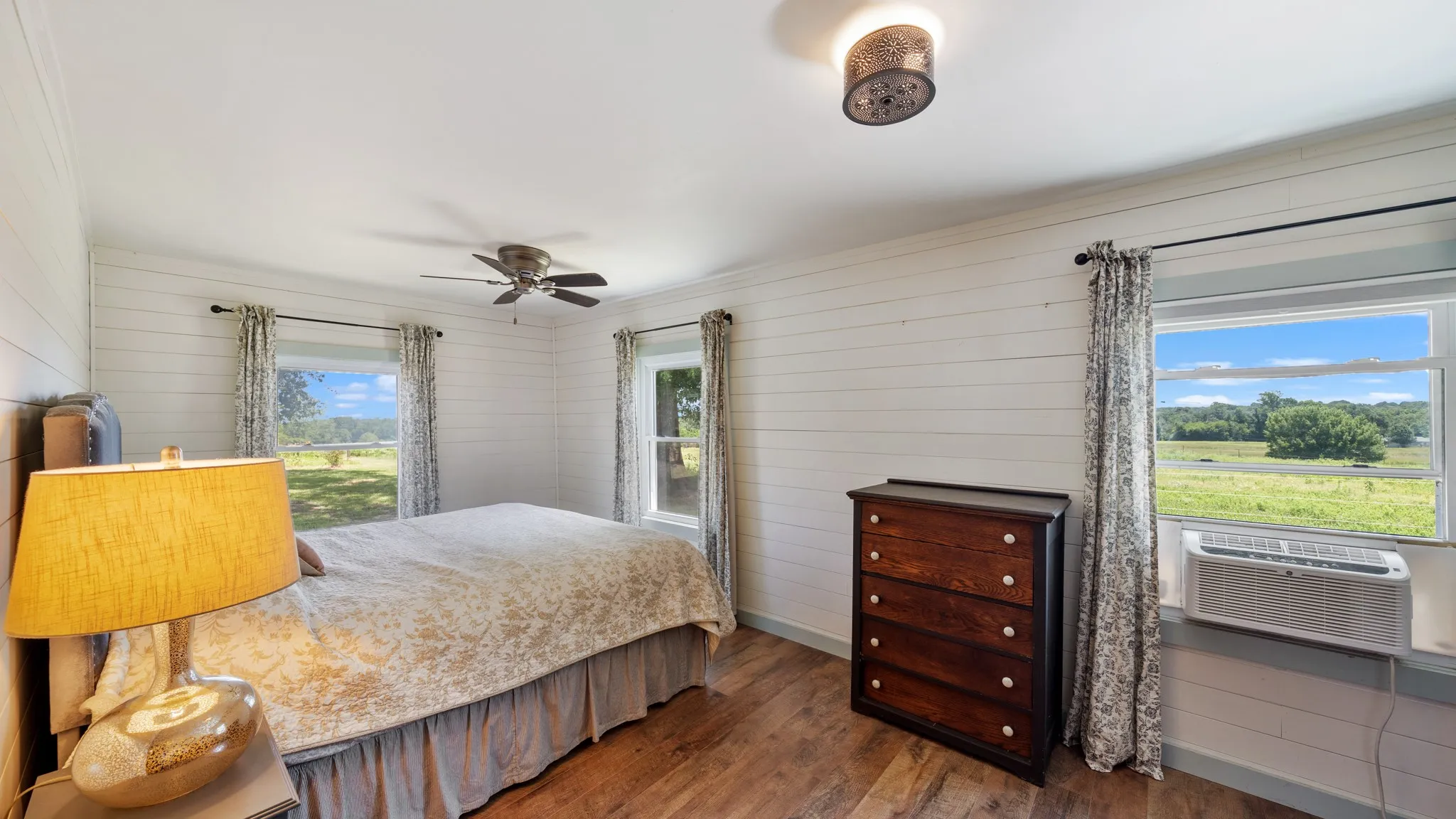 Bright room with wood-finish flooring and white shiplap walls