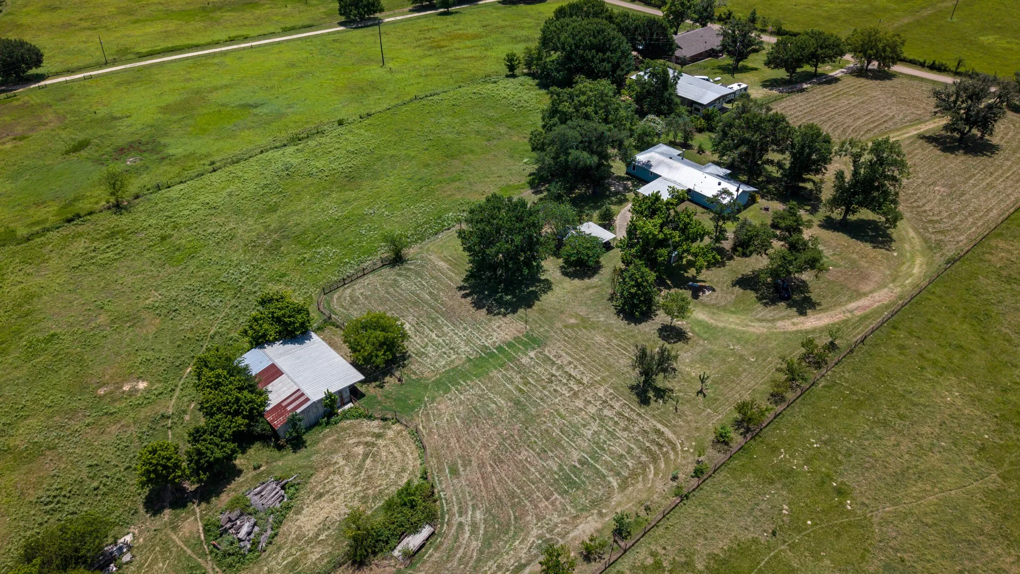Aerial perspective showcasing multiple structures and expansive acreage