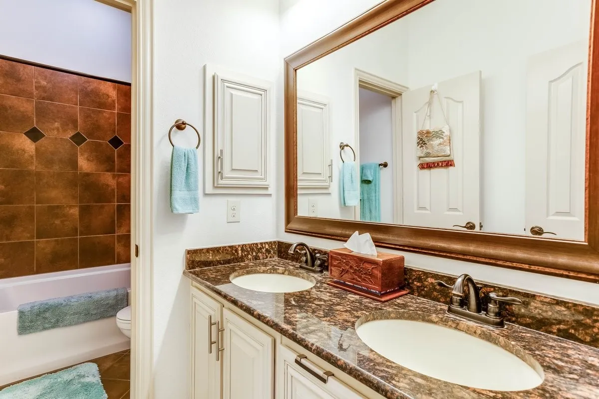 Dual vanity featuring stone countertops and two undermount sinks