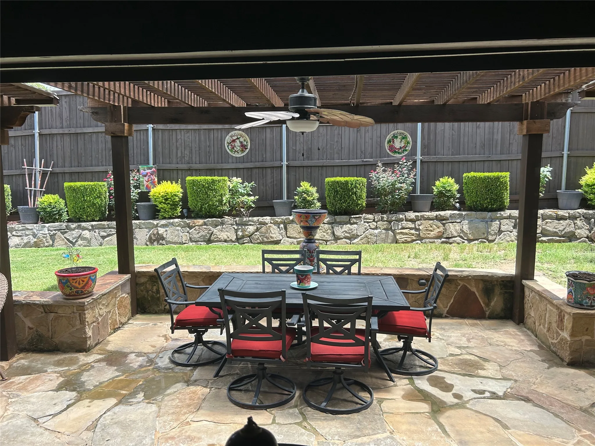 Covered patio featuring a wood pergola and ceiling fan