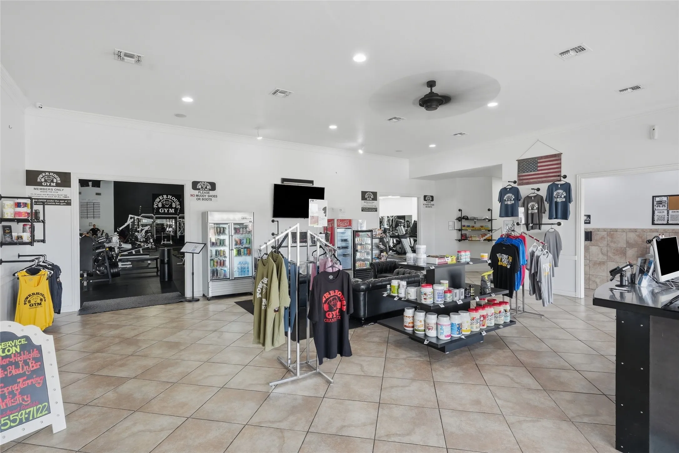 Spacious commercial interior featuring neutral tone tile flooring and recessed lighting