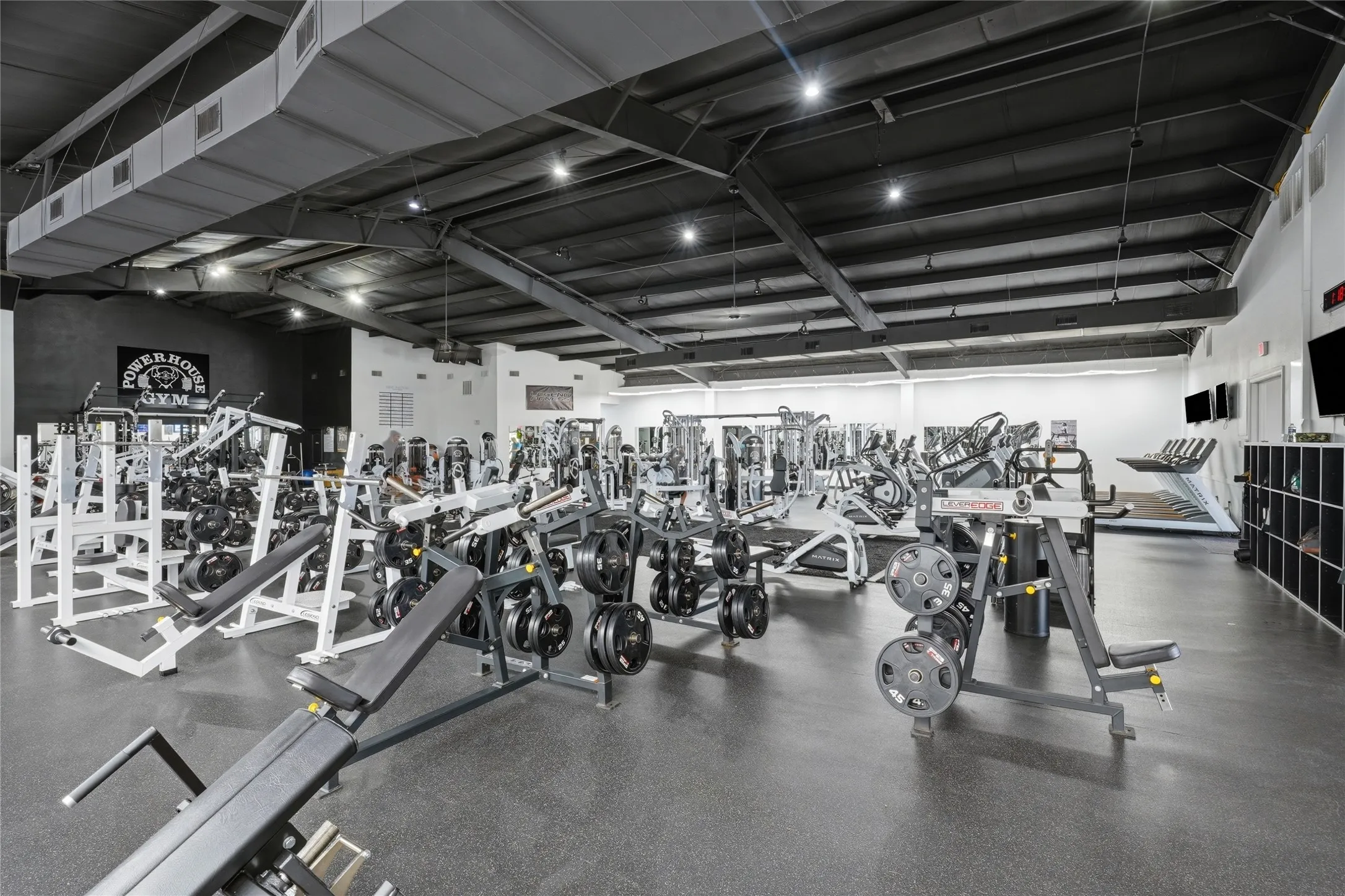 Spacious interior featuring a high, exposed ceiling and industrial-style ductwork