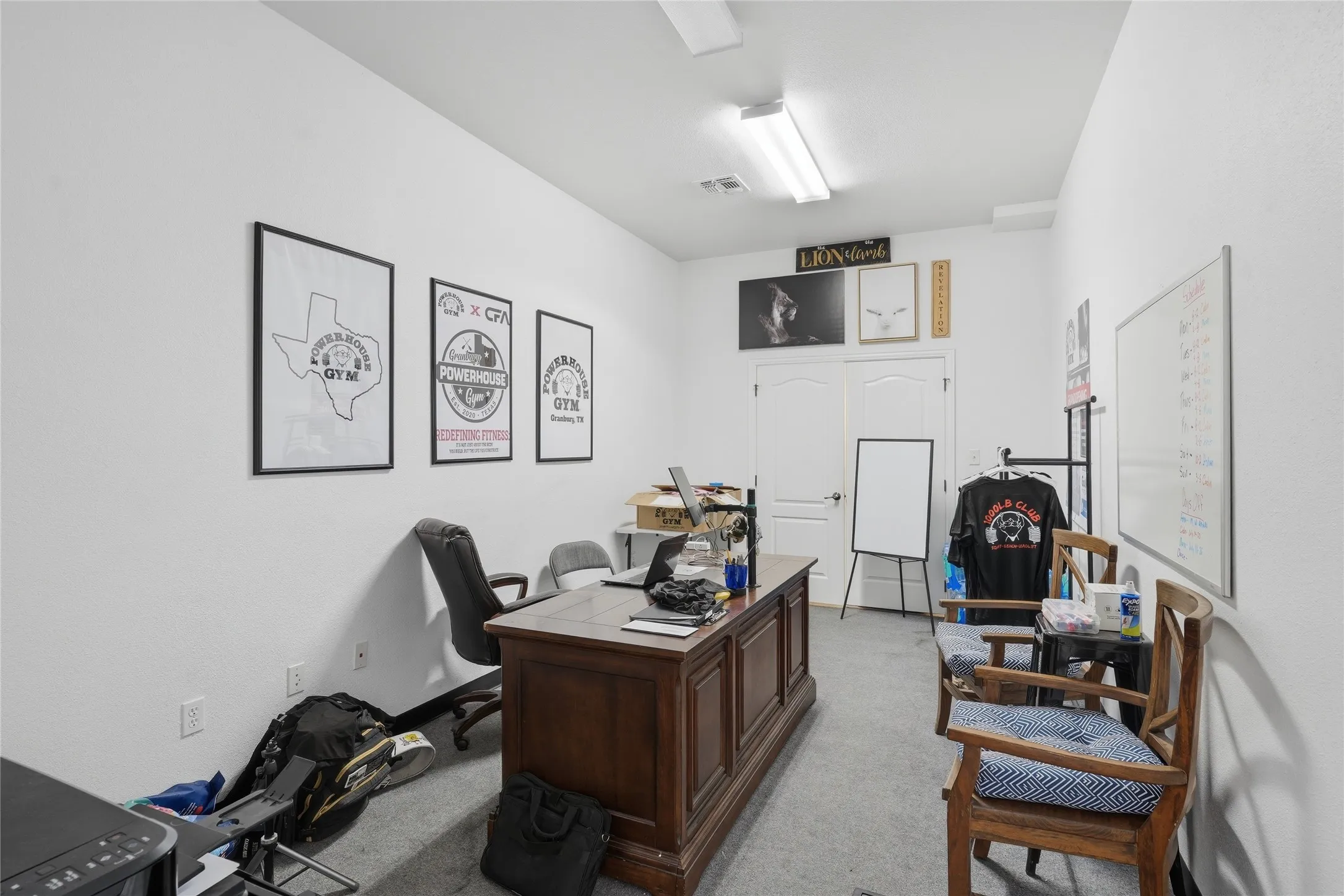 Versatile interior space featuring light-colored walls and grey carpet flooring