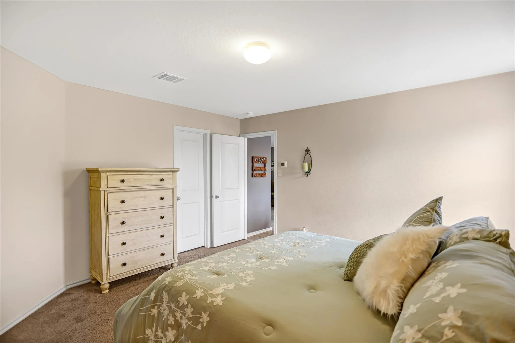 Neutral-toned walls complement a brown carpeted floor