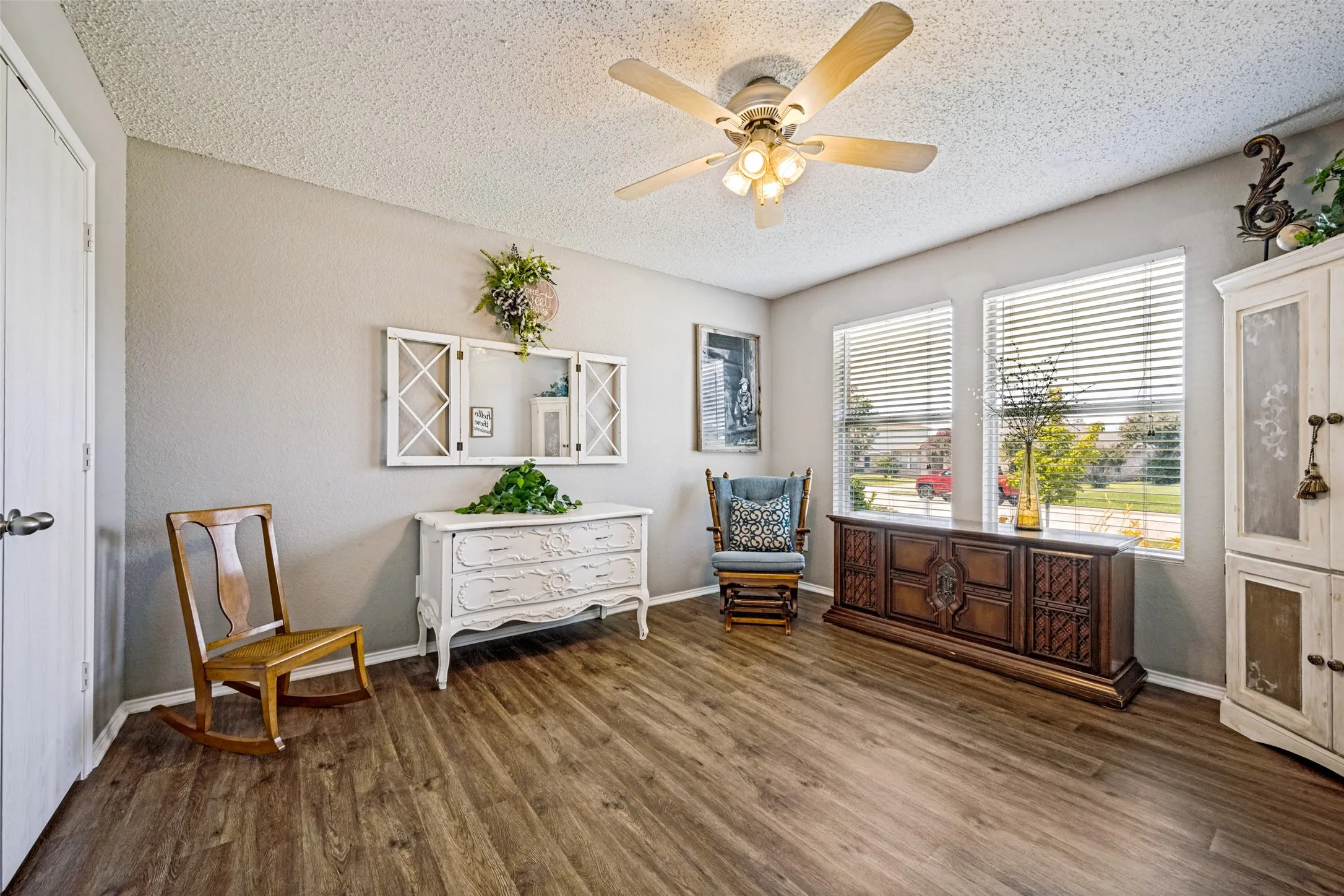 Fourth Bedroom in front of home can be used as a living area, study, playroom, etc. Abundance of natural light, ceiling fan, luxury vinyl plank throughout the home.