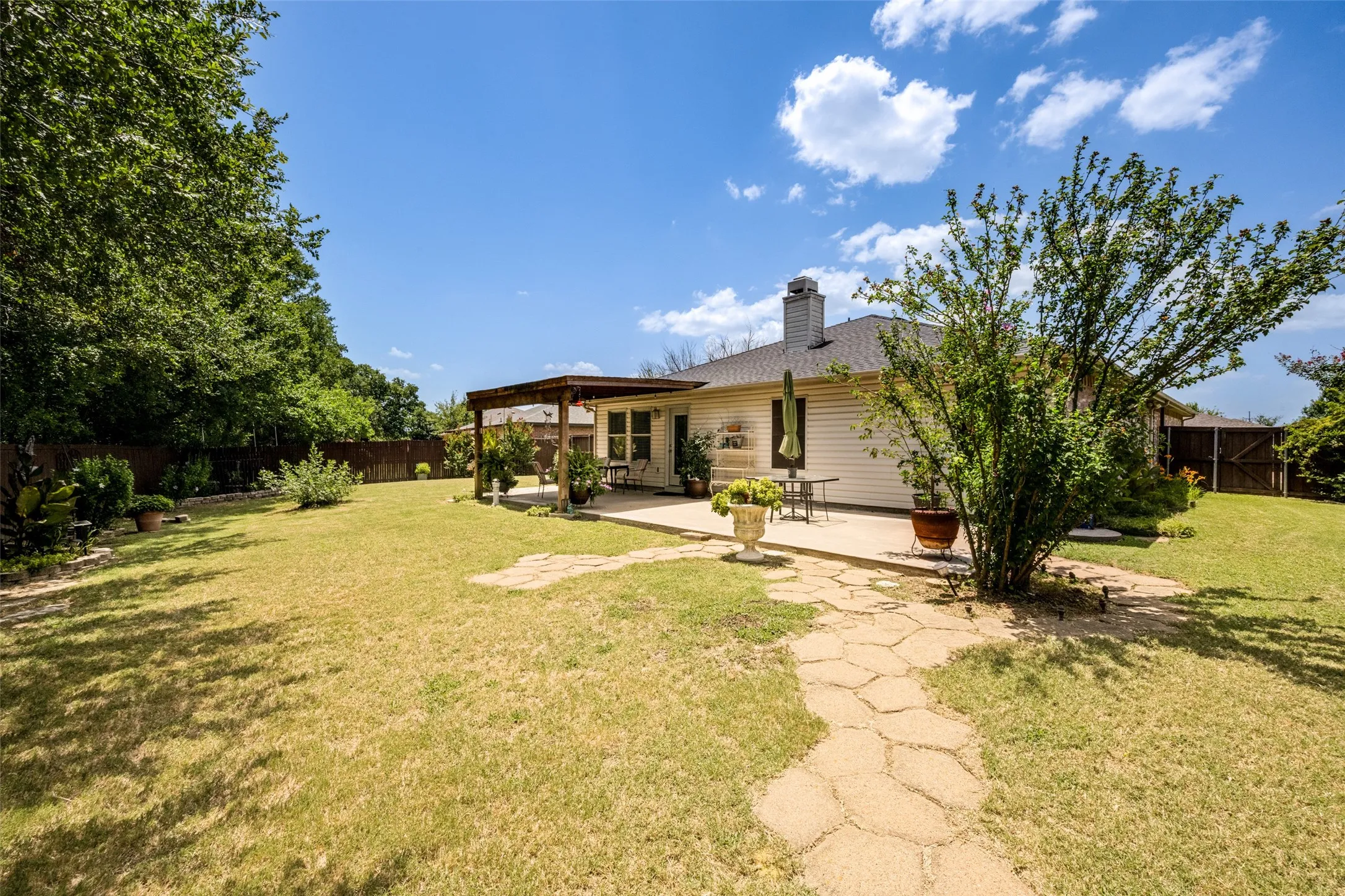 Expansive backyard features a stone pathway leading to the cute 10' X 12' Garden Shed. No lack of outdoor space here.