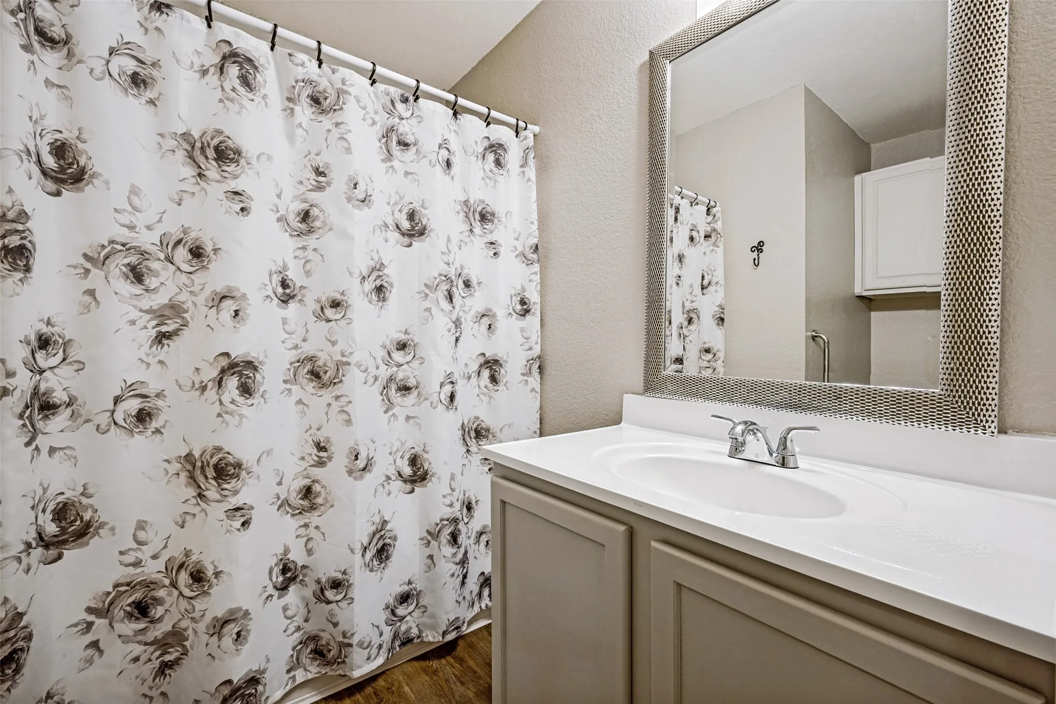 Hall bathroom, in the wing containing the two Split Bedrooms, features a brand new sink countertop and faucet.