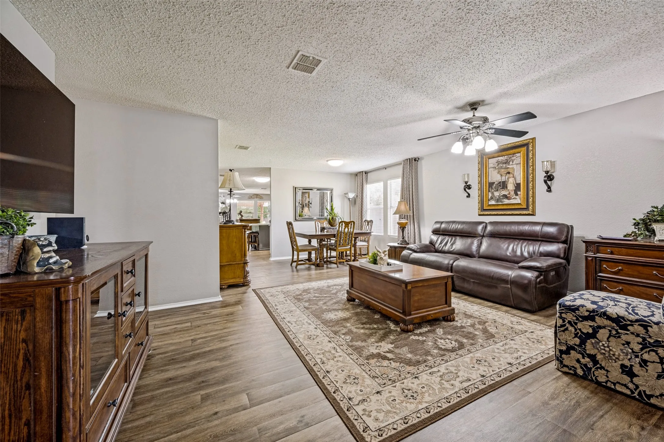Spacious Formal Living area features luxury vinyl plank flooring and ceiling fan. This is a great place for relaxing anytime.