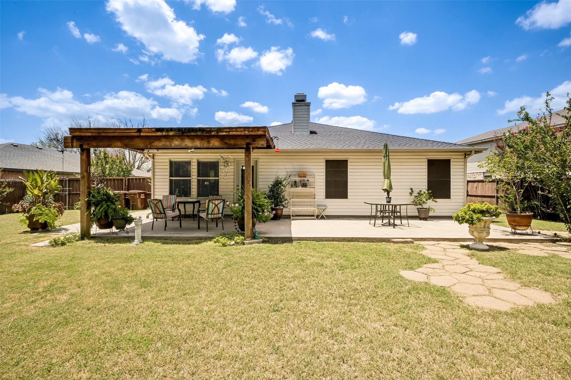 Expansive private backyard features a pergola covered patio, an additional concrete patio, a stone pathway to a cute 10' X 12' Garden Shed, and a privacy fence. Backyard backs to private, heavily treed property, no homes in view.  This backyard is large enough to have a pool, garden and still have plenty of green space for kids or pets.